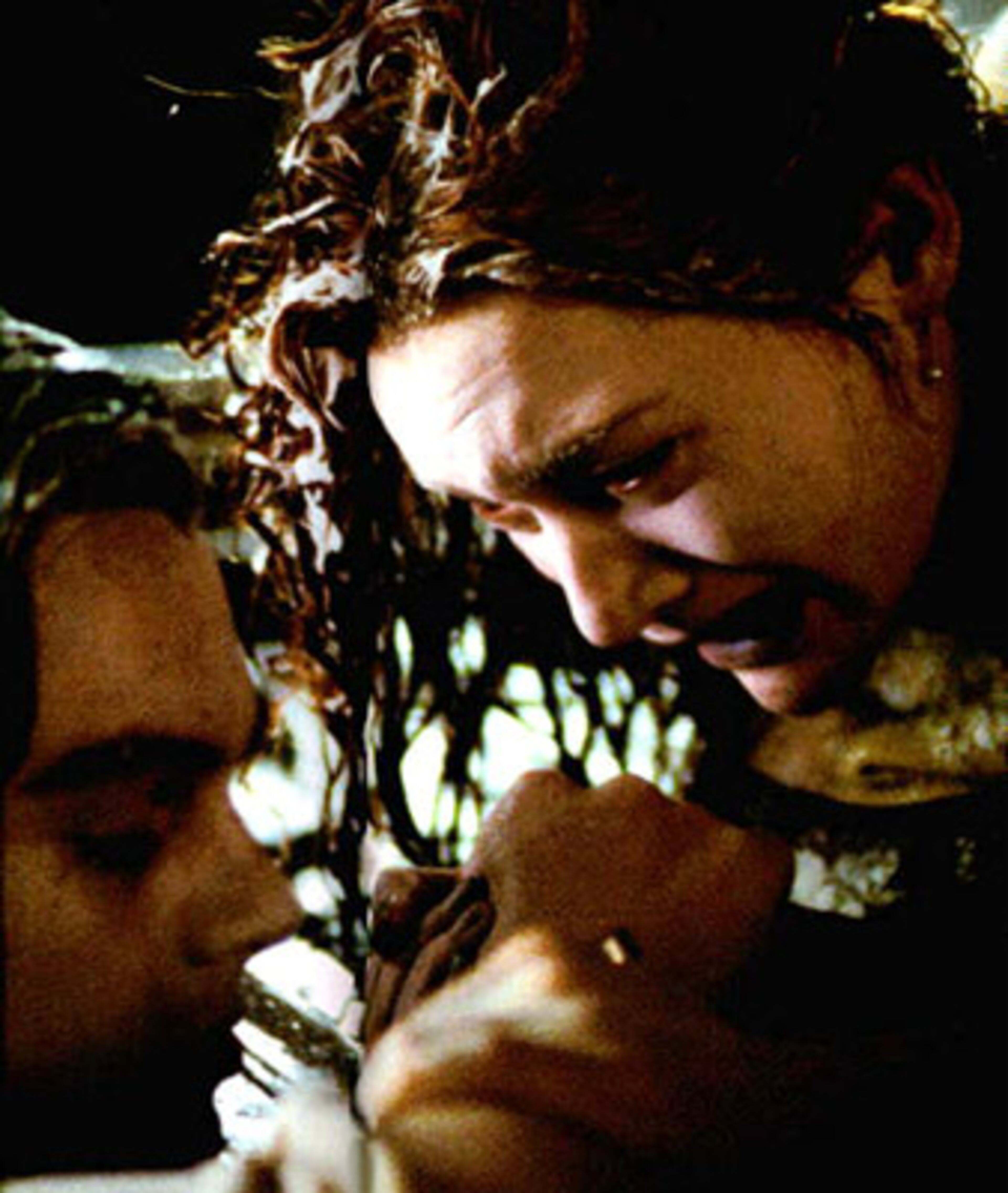 Jack (Leonardo DiCaprio) and Rose (Kate Winslet) find love on the decks of the 'Titanic.' As the two float in the icy Atlantic waters after the ship has sunk, he kisses her, and she promises to never let him go before he dies. Now who needs a Kleenex?