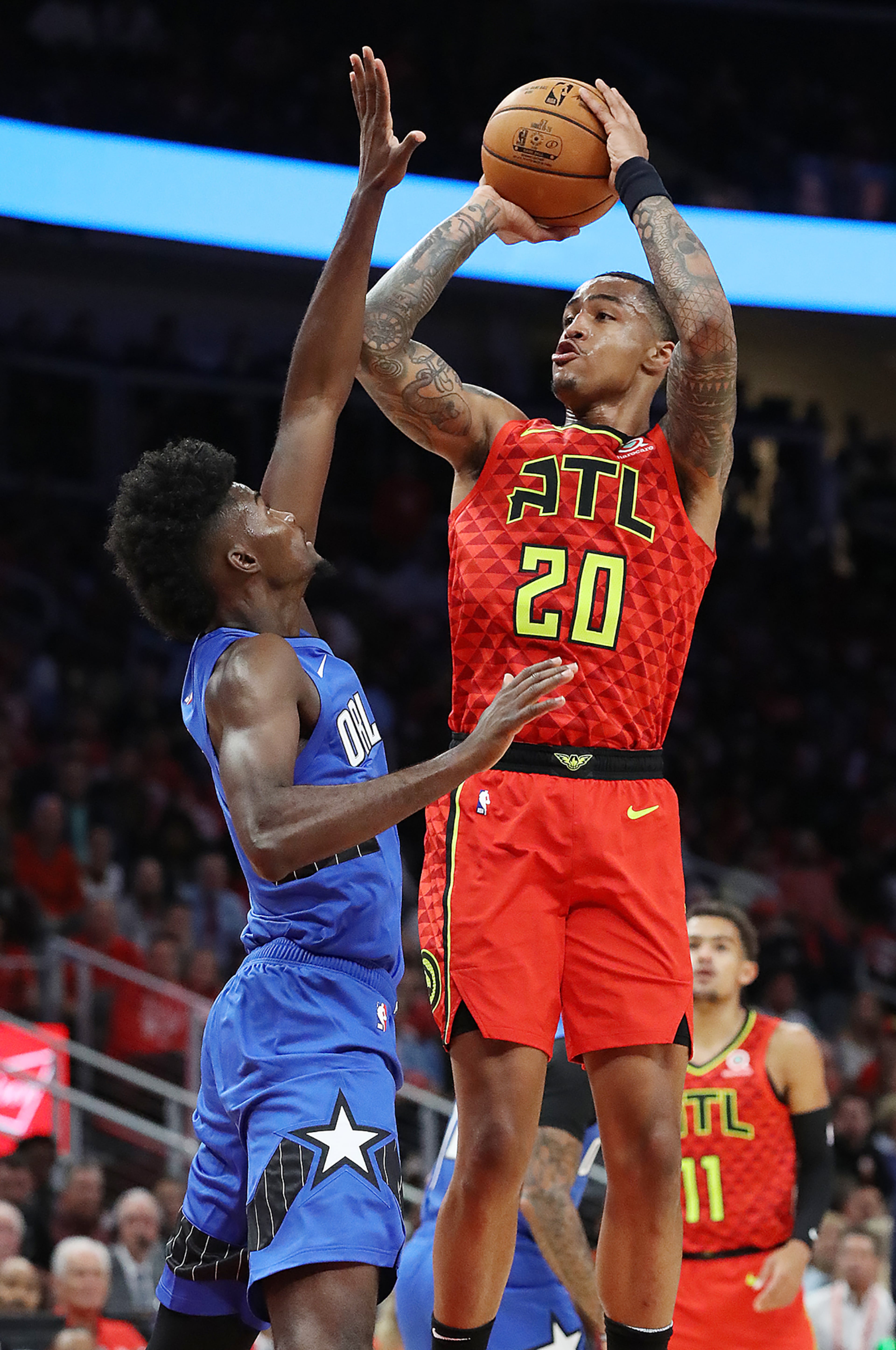 Hawks forward John Collins shoots for two over Orlando Magic forward Jonathan Isaac in the home opener in a NBA basketball game on Saturday, October 26, 2019, in Atlanta. Curtis Compton/ccompton@ajc.com