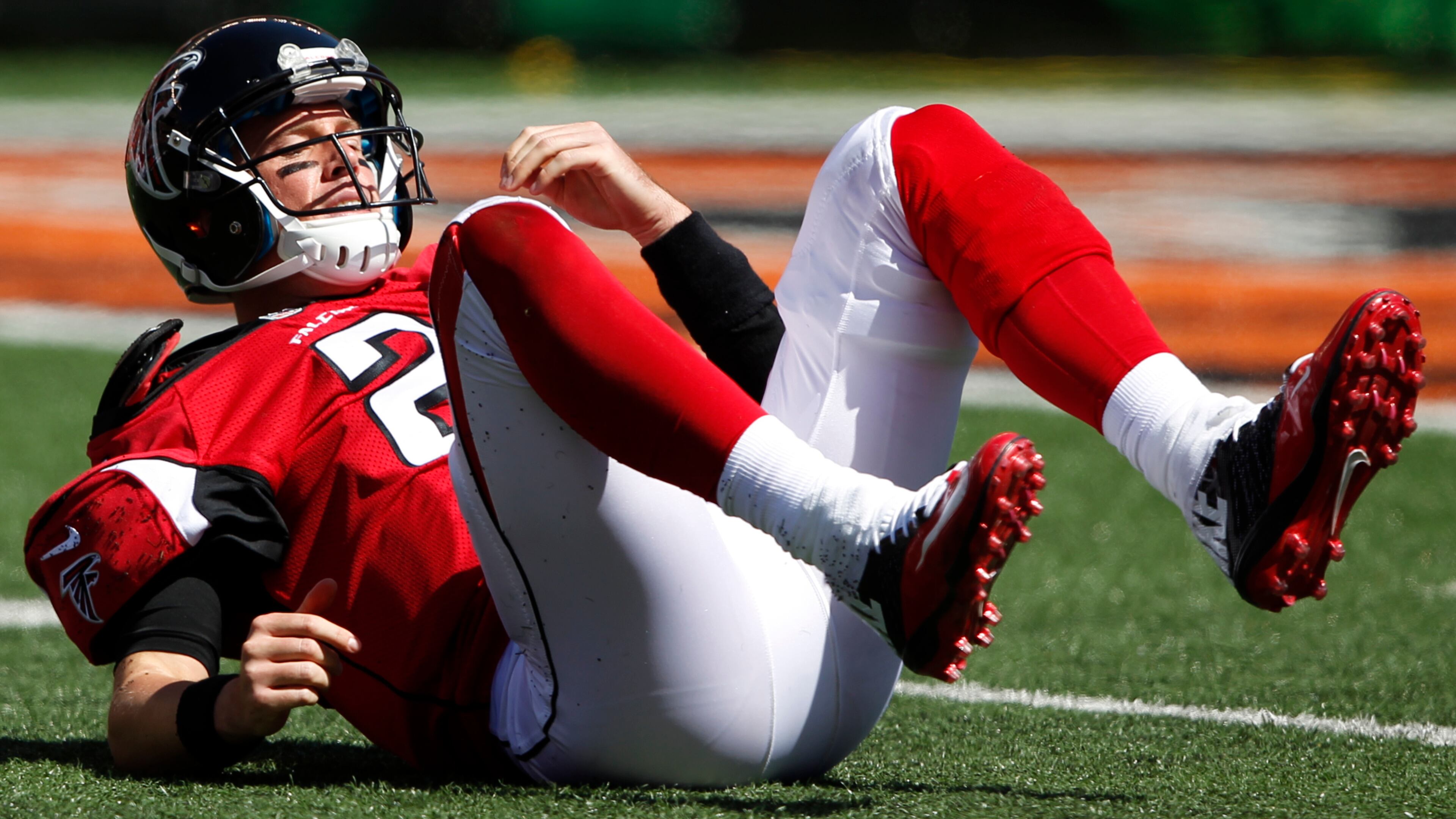 Atlanta Falcons quarterback Matt Ryan rolls on the ground after being hit in the first half of an NFL football game against the Cincinnati Bengals, Sunday, Sept. 14, 2014, in Cincinnati. (AP Photo/Frank Victores) Matt Ryan struggled behind Falcons' banged up offensive line. (AP photo)