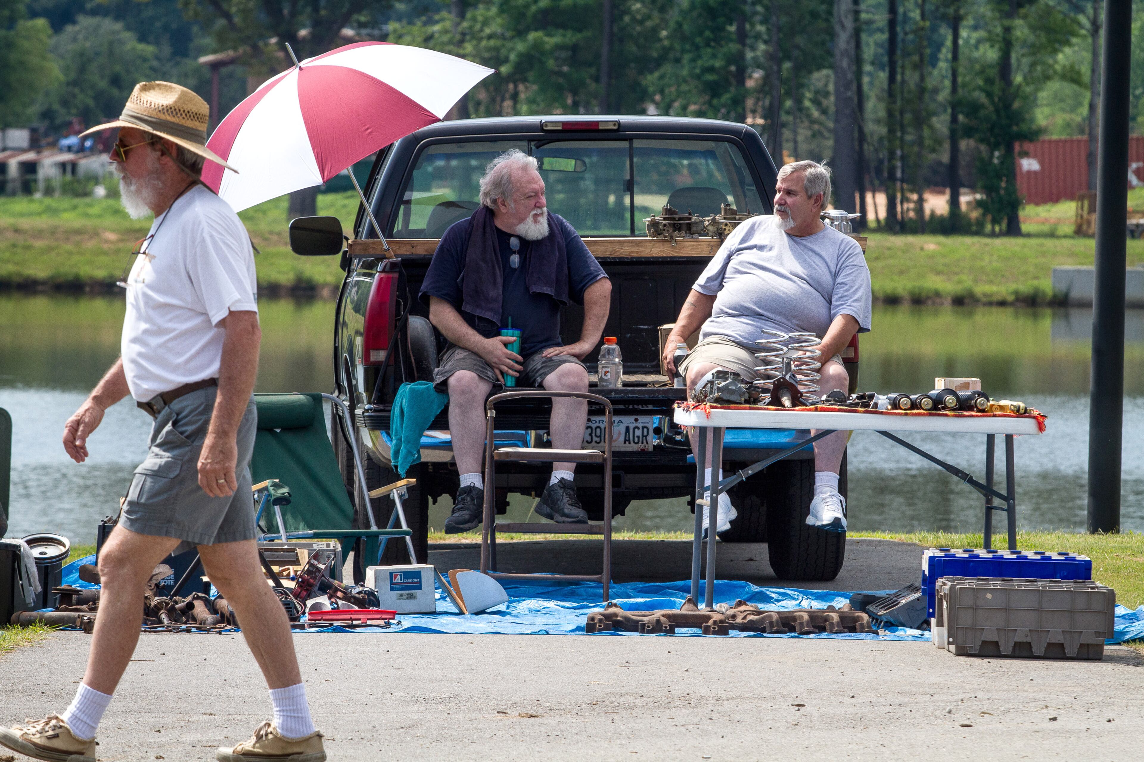 Vic Carroll, left, and John Schneider talk while waiting for customers in the swap meet area of the 28th annual Creepers Car Show at Jim R. Miller Park in Marietta on Saturday. STEVE SCHAEFER / SPECIAL TO THE AJC