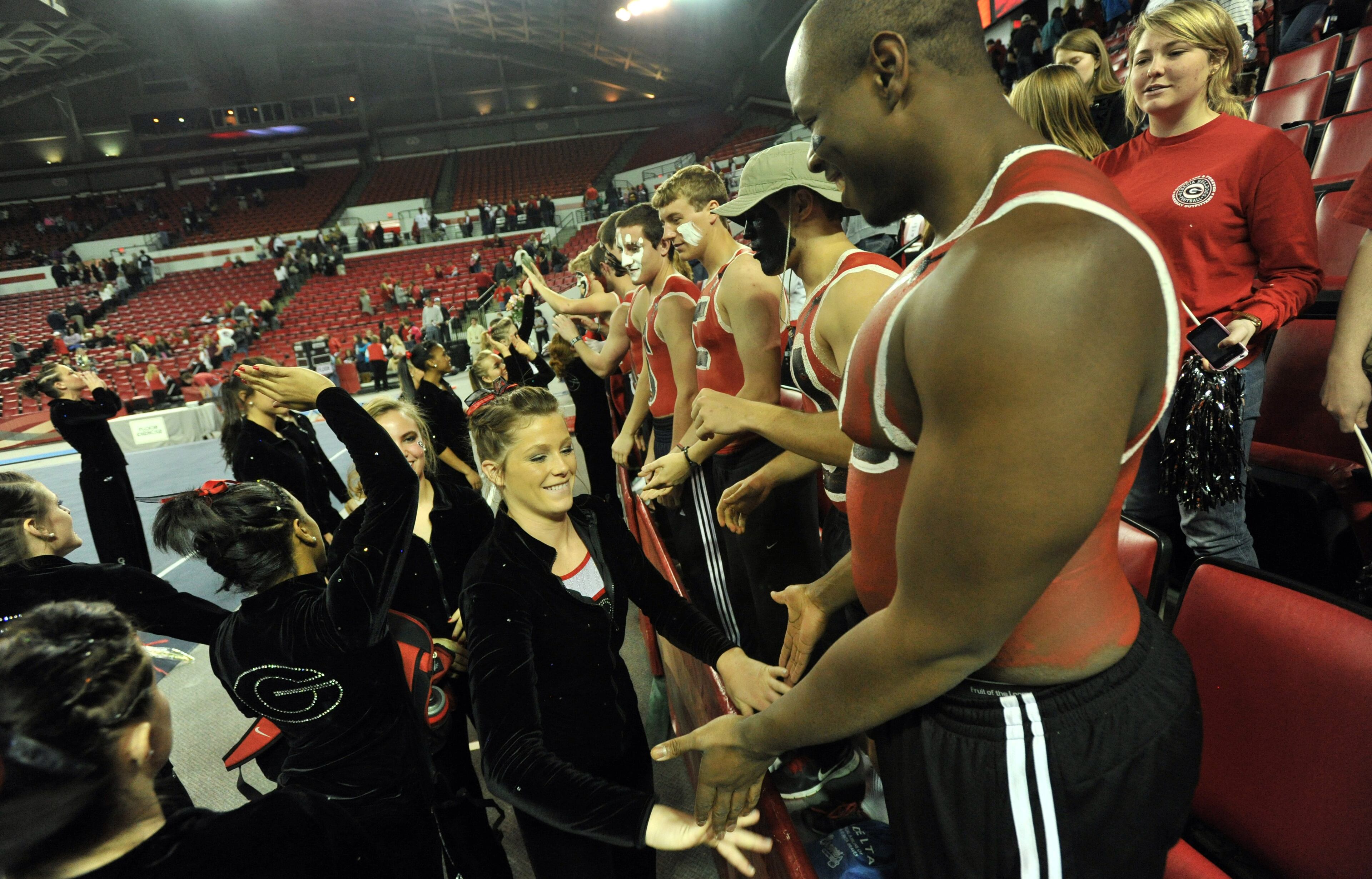 January 5, 2013 Athens - Georgia Gym Dog Cat gymnasts celebrate after they competed against University of Oklahoma at Stegeman Coliseum in Athens on Saturday, Jan. 5, 2013. University of Oklahoma scored 196.450. University of Georgia scored 195.425. HYOSUB SHIN / HSHIN@AJC.COM
