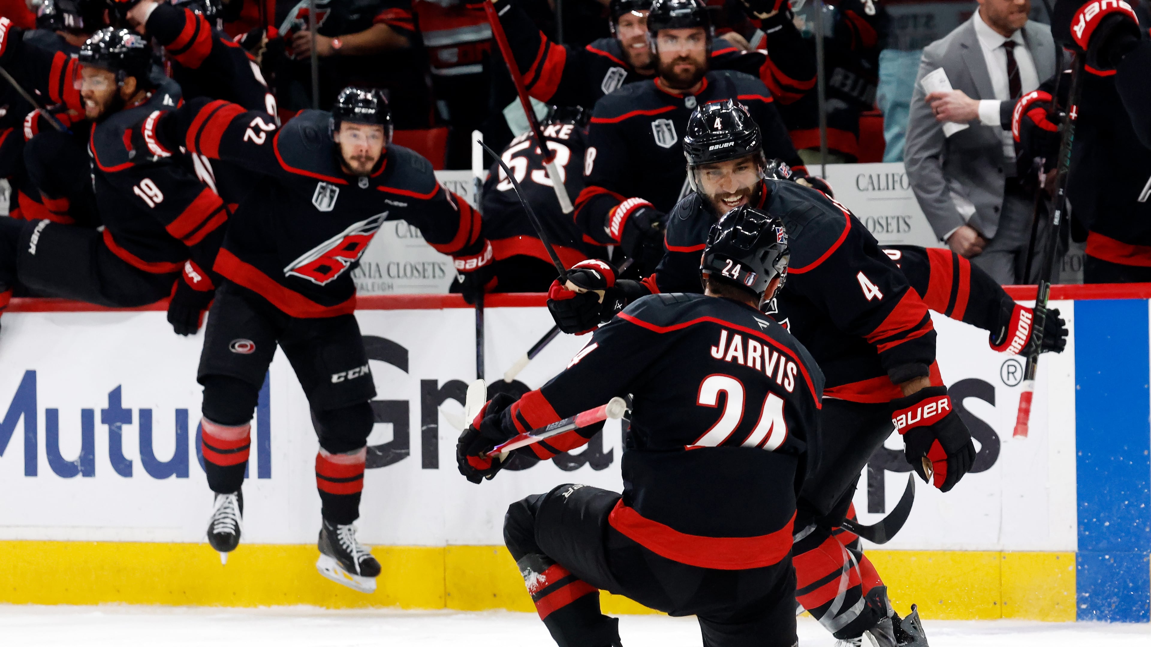 Carolina Hurricanes' Seth Jarvis (24) celebrates after his winning goal with Shayne Gostisbehere (4) during the overtime period in Game 2 of the NHL hockey Stanley Cup Final series against the Vegas Golden Knights in Raleigh, N.C., Thursday, June 4, 2026. (AP Photo/Karl DeBlaker)