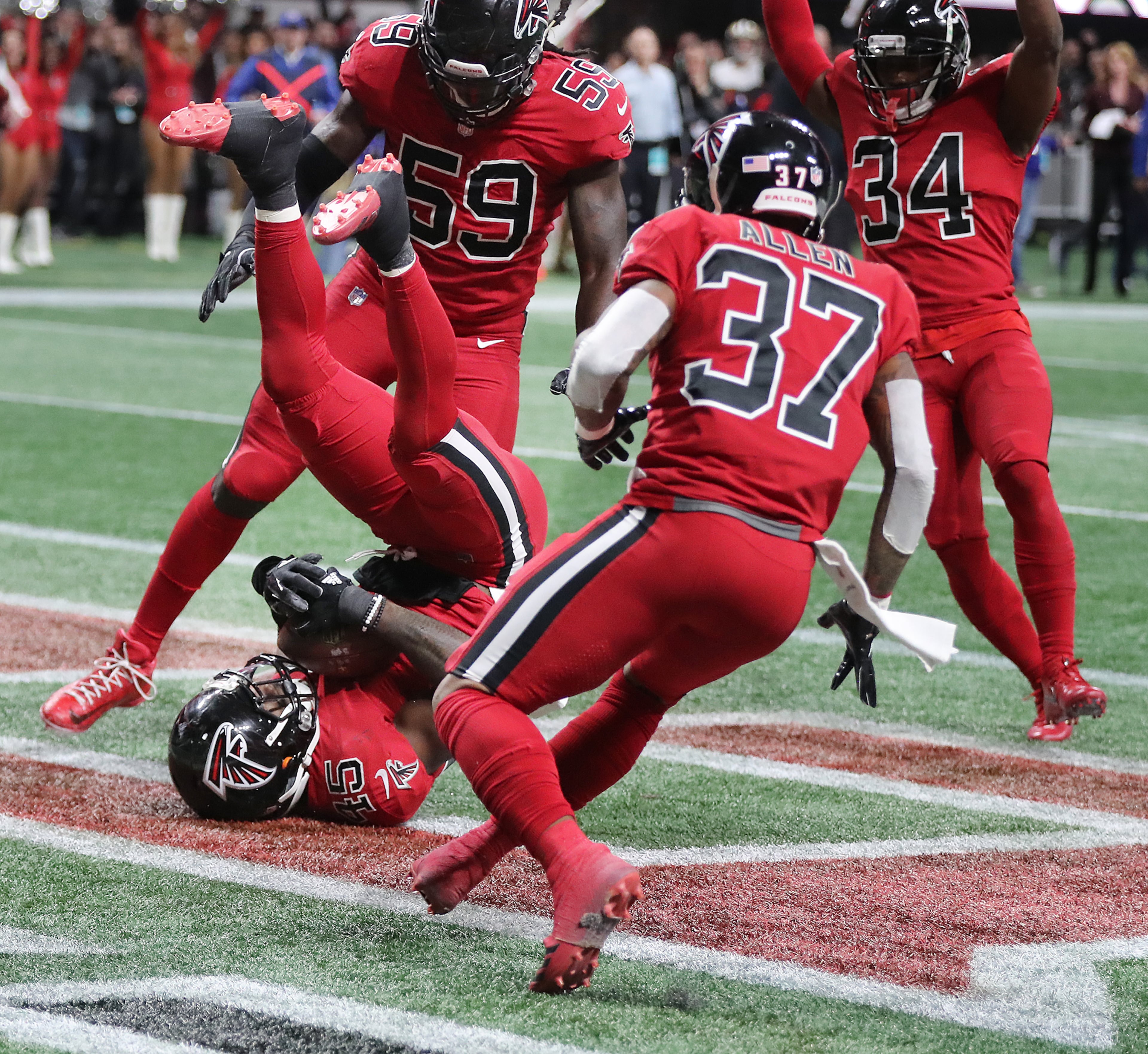 December 7, 2017 Atlanta: The celebration begins as Falcons linebacker Deion Jones hits the ground intercepting Saints quarterback Drew Brees pass intended for tight end Josh Hill in the endzone to hold on to a 20-17 victory in a NFL football game on Thursday, December 7, 2017, in Atlanta. Curtis Compton/ccompton@ajc.com