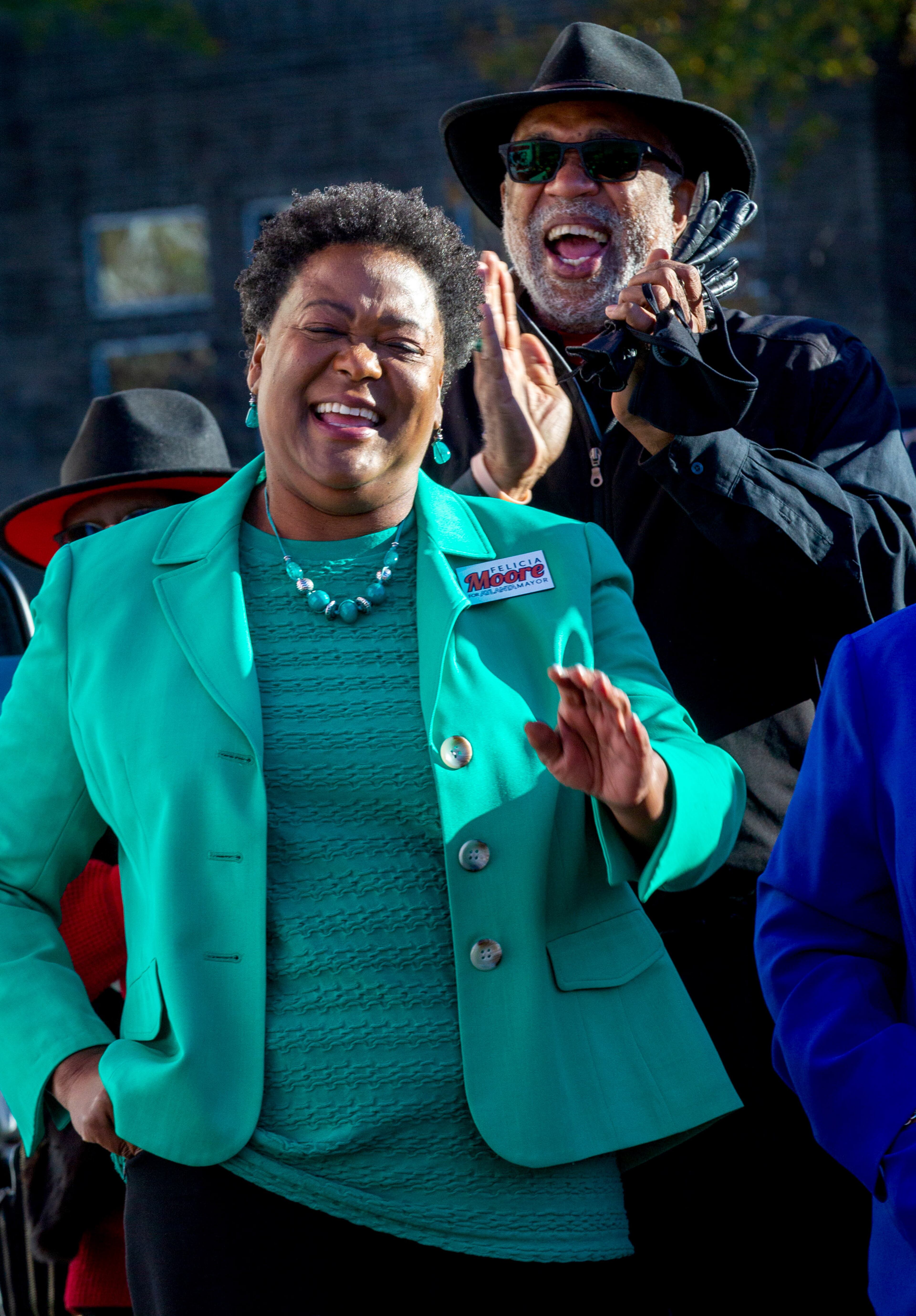 Atlanta mayoral candidate Felicia Moore and State House Representative Dewey McClain listen to the speakers at a get-out-the-vote rally in Atlanta Monday, November 29, 2021. STEVE SCHAEFER FOR THE ATLANTA JOURNAL-CONSTITUTION