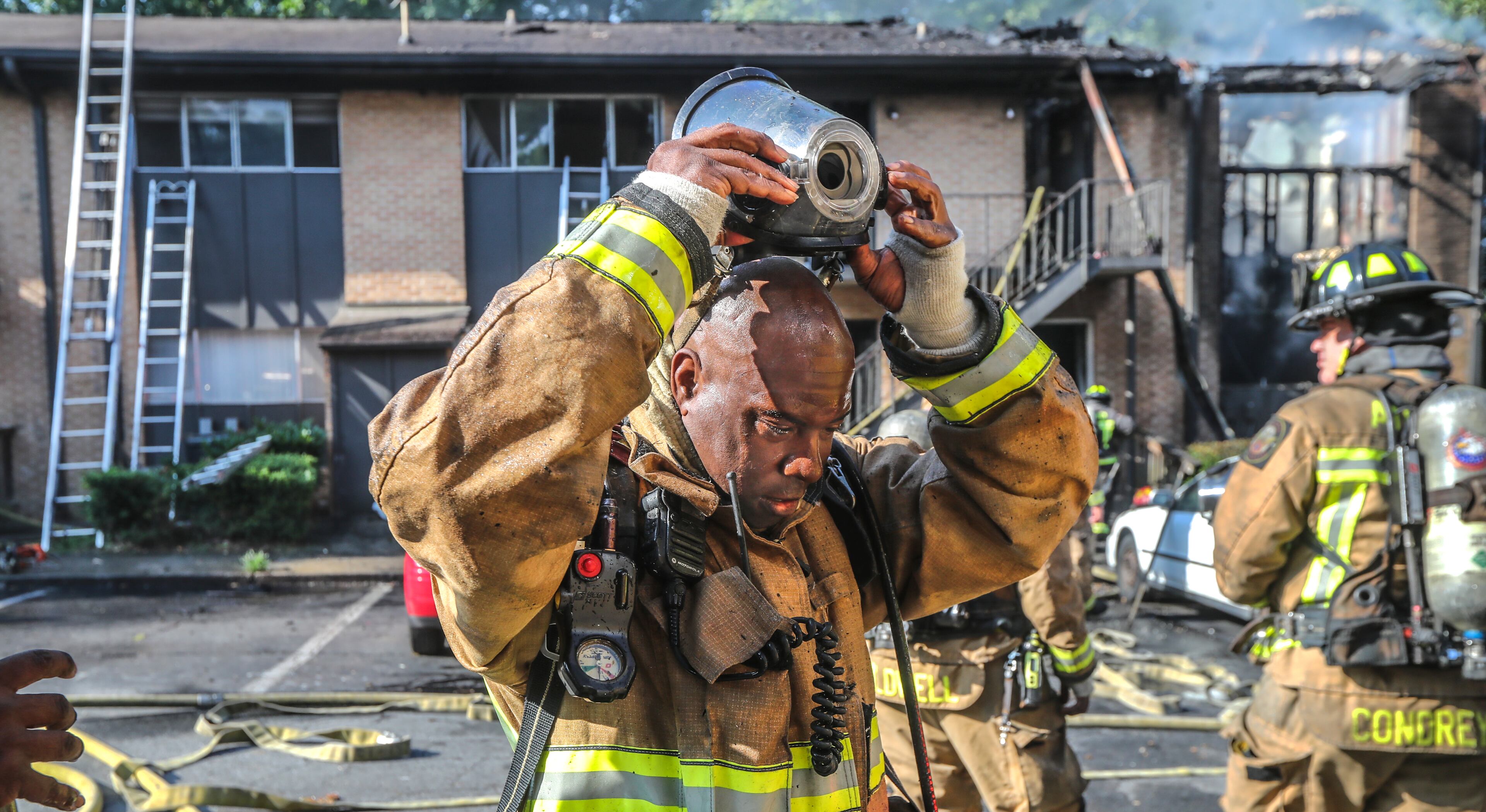 July 7, 2022 Atlanta: Atlanta firefighters had a hot morning battling an apartment blaze in the 2200 block of Campbellton Road in Atlanta on Thursday, July 7, 2022. The call came in at 9 am for the Adams House Apartments where units arrived to heavy smoke conditions according to Atlanta Fire Rescue Captain Taurus Durrah. Flames erupted from the bottom floor to the top floor and then the attic Durrah said. Crews initially had to bring in tank water to get water on the fire because of the 800 foot distance to the hydrant on Campbellton Road. Four units were damaged and 8-families displaced. No one was injured and the fire is under investigation. Durrah said more units are being sent to fire scene to shorten the rotation of fire crews due to the heat. Firefighters are told to hydrate and stay cool a full shift before coming to work to combat the heat. (John Spink / John.Spink@ajc.com)