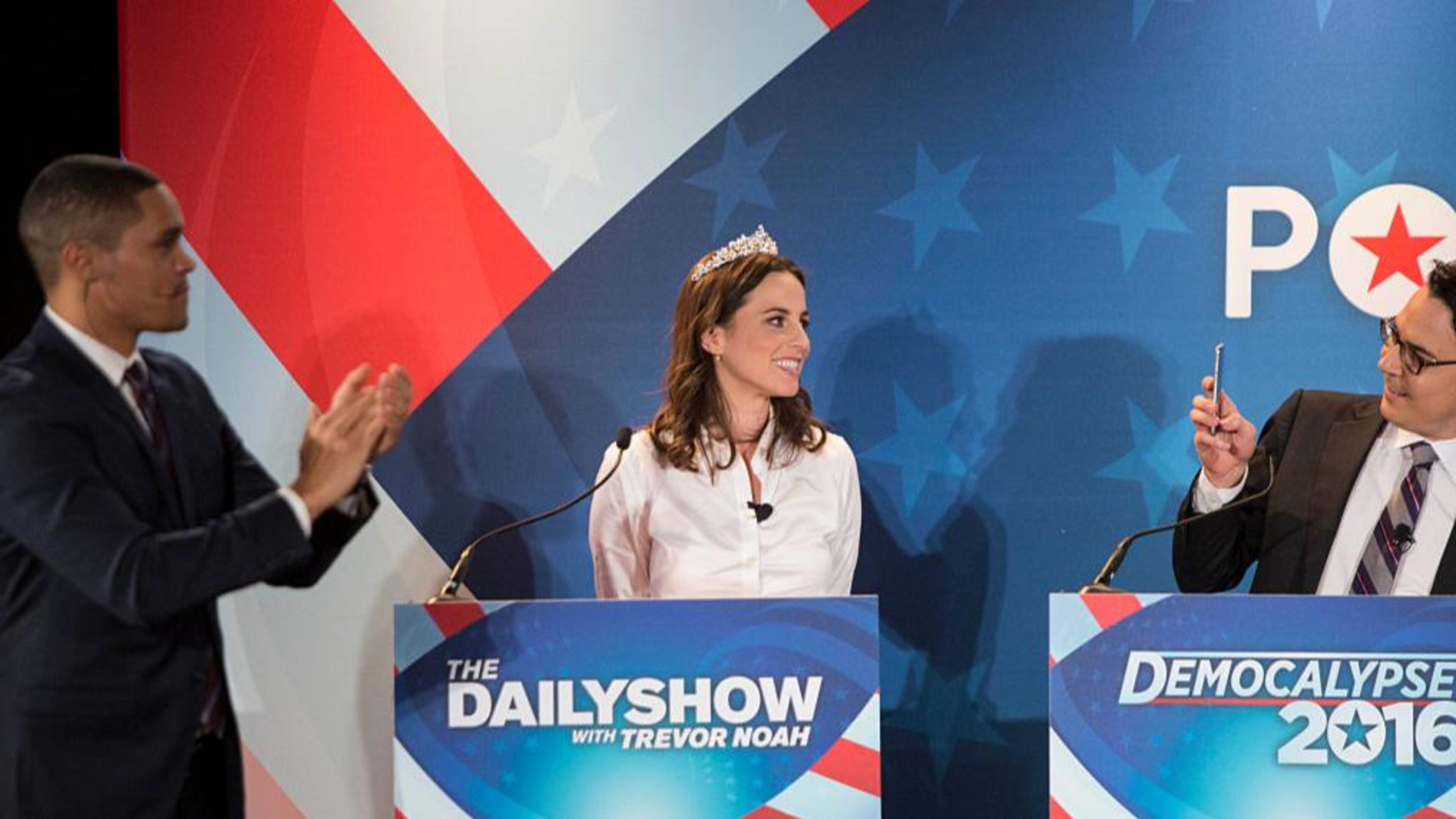 Ryan Lizza, Washington Correspondent for The New Yorker, (right) takes a picture of Alicia Menendez, (center) as Trevor Noah applauds during Comedy Central's "The Daily Show with Trevor Noah" Presents "Podium Pandemonium: A Debate About Debates," in February of 2016.