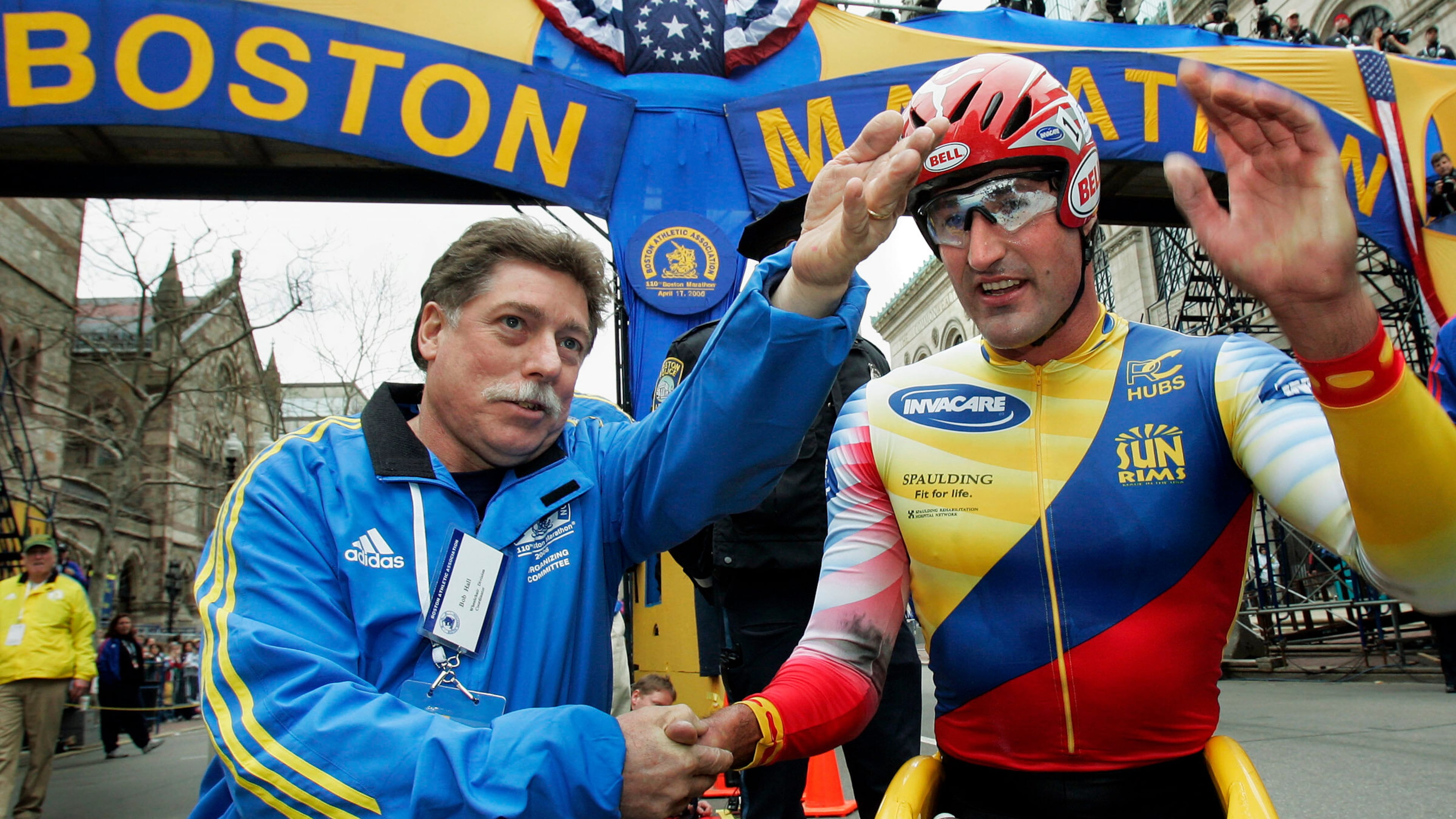 FILE - Ernst Van Dyk of South Africa, right, shakes hands with former wheelchair winner Bob Hall, after he won the mens wheelchair division of the 110th running of the Boston Marathon, Monday, April 17, 2006. (AP Photo/Elise Amendola, File)