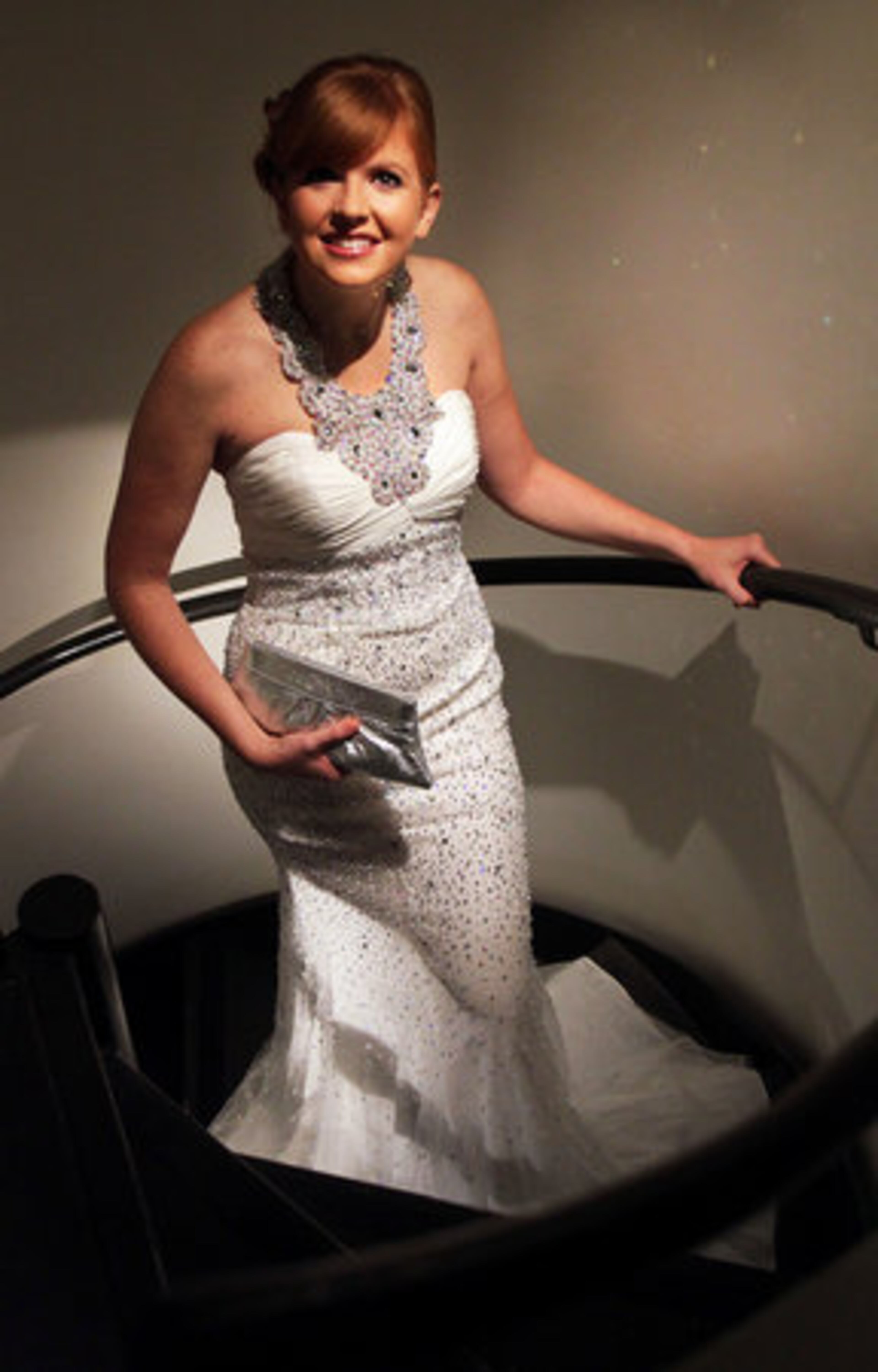 Make a grand entrance in a white halter dress with a beaded neckline and embellished tulle skirt.