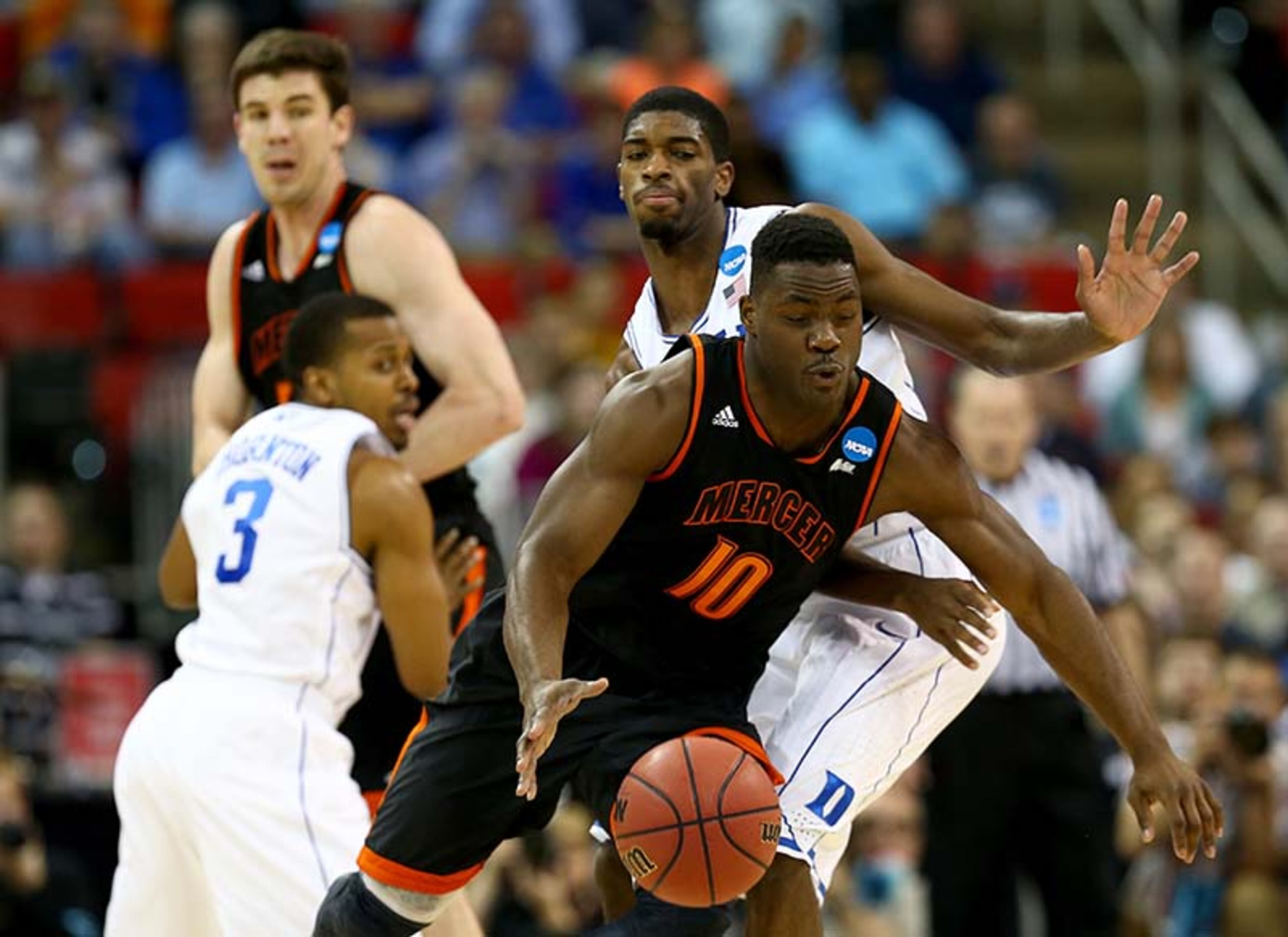 Ike Nwamu #10 of the Mercer Bears with the ball against Amile Jefferson #21 of the Duke Blue Devils in the second half in the second round of the 2014 NCAA Men's Basketball Tournament at PNC Arena on March 21, 2014 in Raleigh, North Carolina.