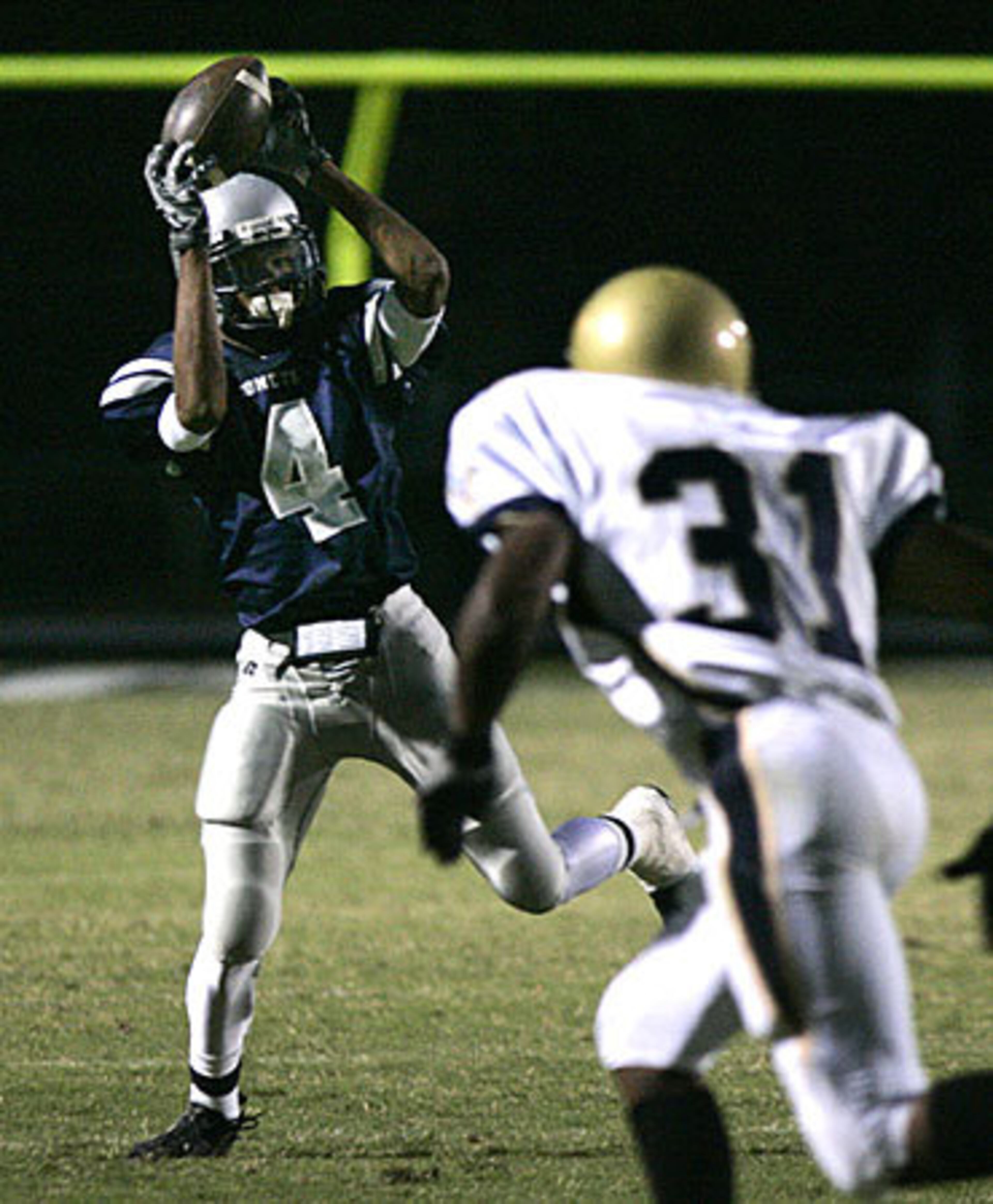 South Gwinnett wide receiver Johnathan Krause (4) makes a catch in front of Dacula defensive back Darien Lane.