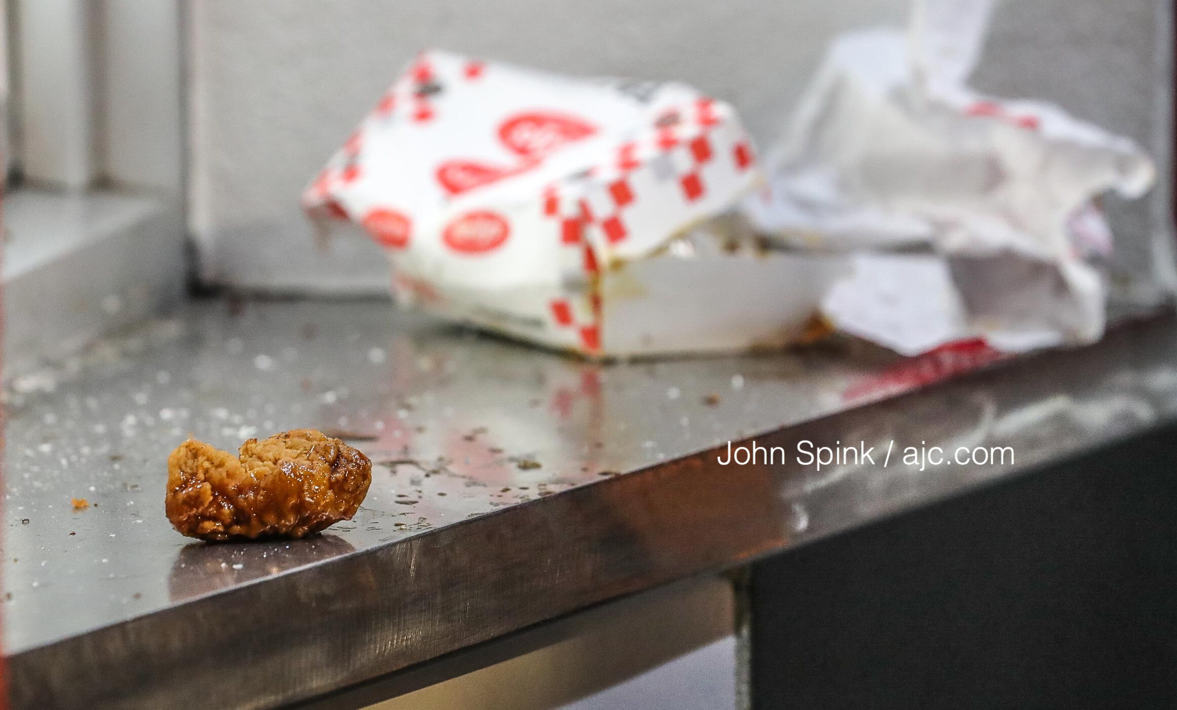 Discarded chicken is left on the counter after a Checkers employee allegedly shot an angry customer at the Candler Road location, a manager told Channel 2 Action News.