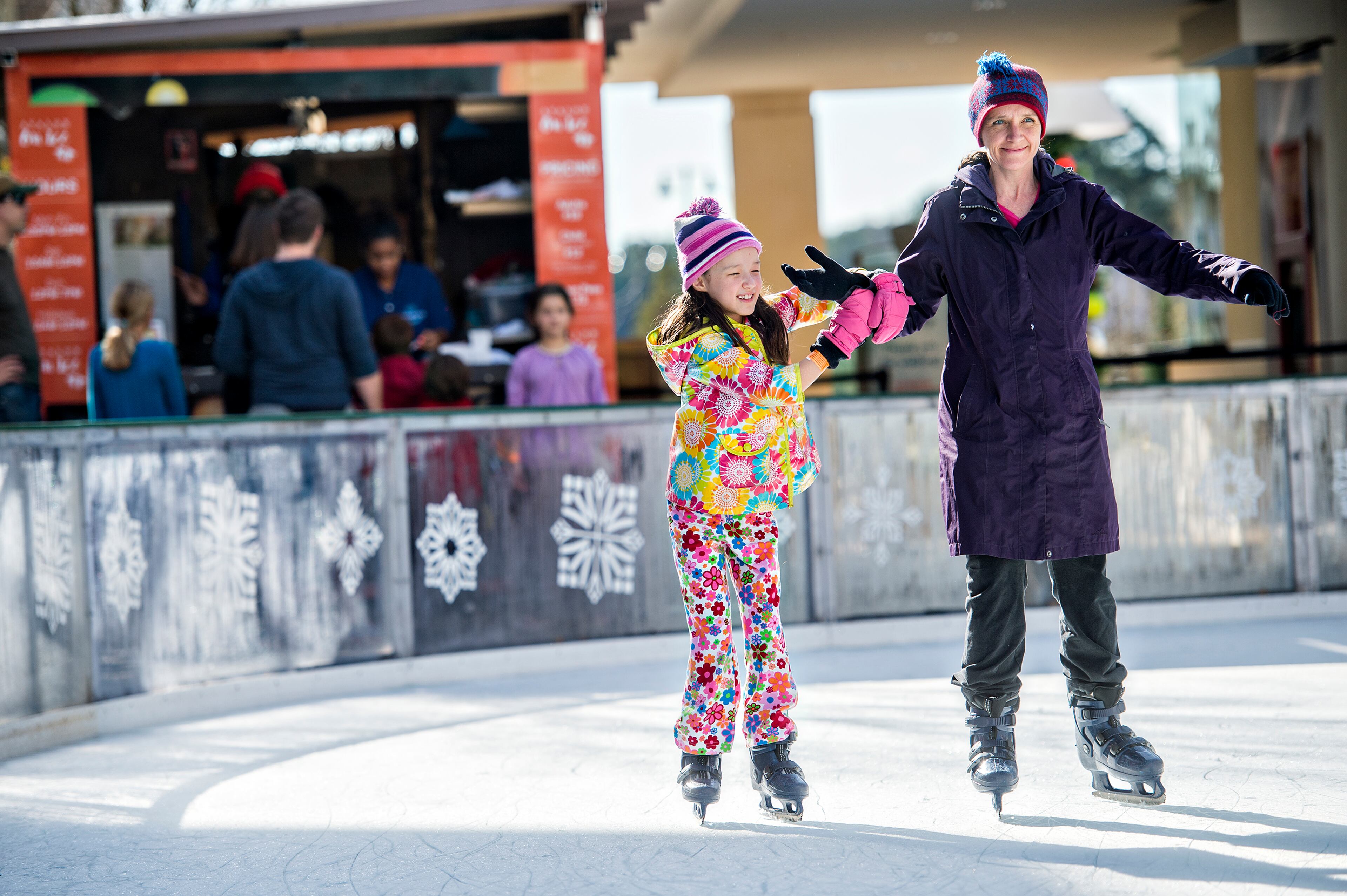December 26, 2015 Alpharetta - Serah Lee (left) skates with her mother Michelle at the ice rink at Avalon in Alpharetta on Saturday, December 26, 2015. Unseasonably warm weather has caused some rinks around the metro area to close but Avalon is one that has stayed the course. JONATHAN PHILLIPS / SPECIAL