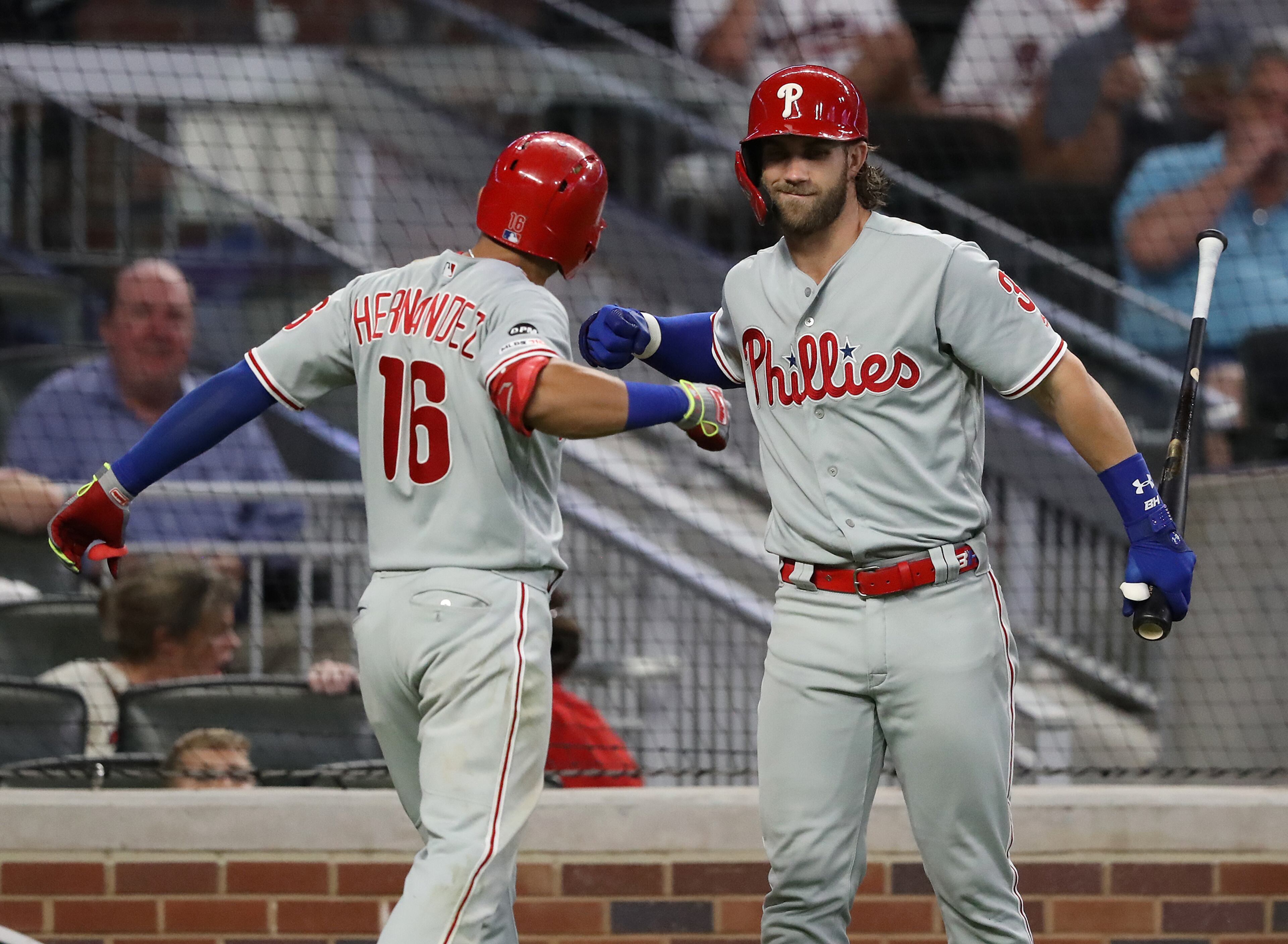 Phillies' Cesar Hernandez celebrates his home run with Bryce Harper for a 3-1 lead. Curtis Compton/ccompton@ajc.com