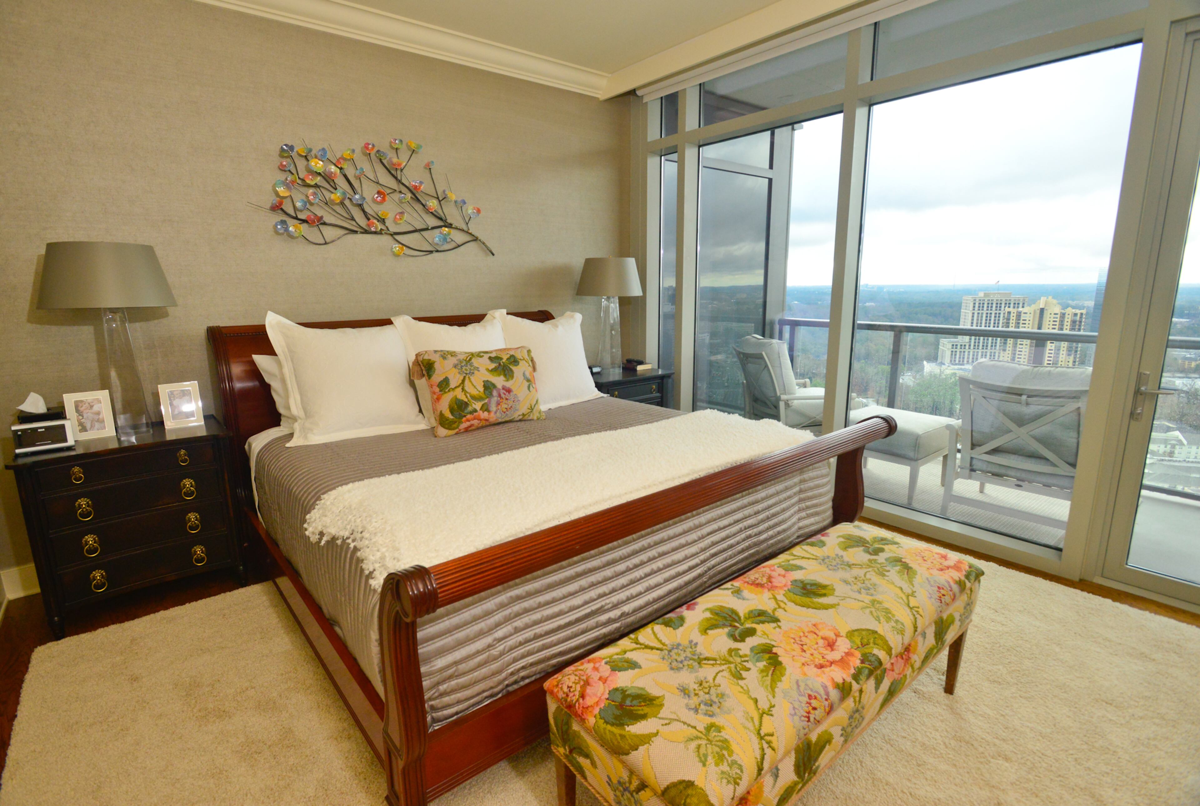 The condo's floor-to-ceiling windows extend to the master bedroom, which also has a balcony that offers the Kanovs a private escape.