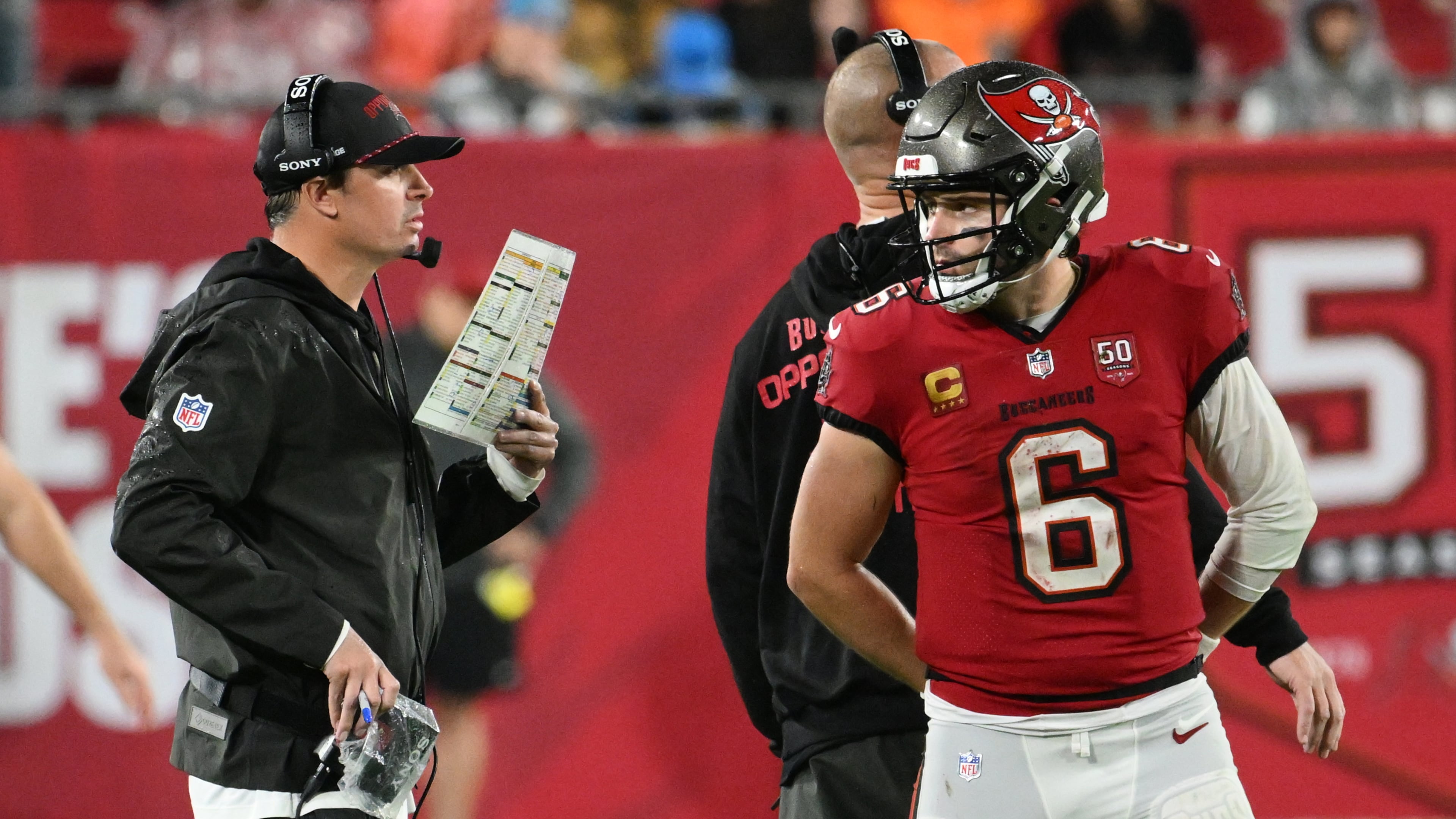 Tampa Bay Buccaneers quarterback Baker Mayfield (6) talks to offensive coordinator Josh Grizzard during the second half of an NFL football game Saturday, Jan. 3, 2026, in Tampa, Fla. (AP Photo/Jason Behnken)