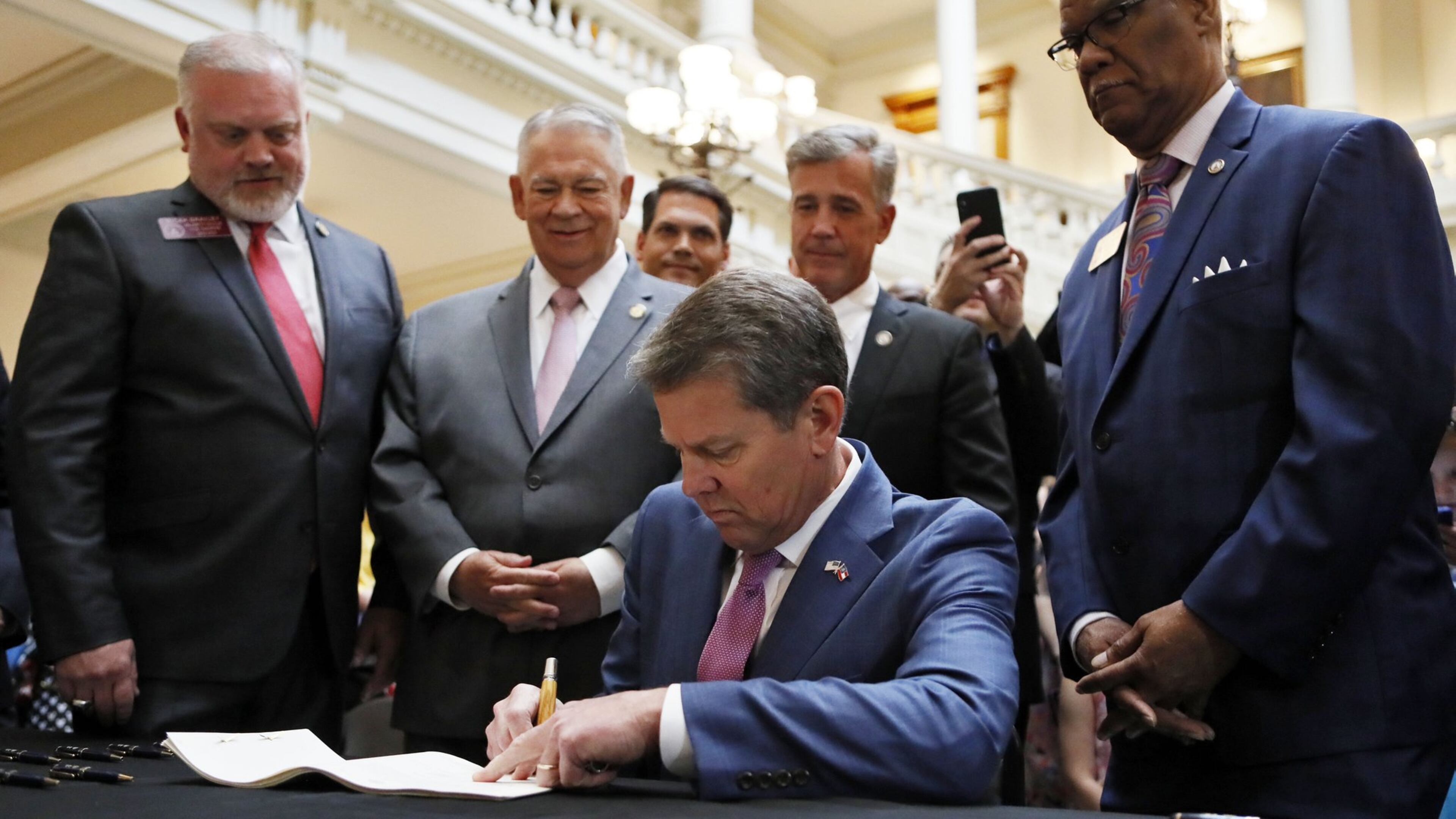 Shannon Cloud, left, and her 13-year-old daughter, Alaina, attended a Senate committee hearing on a bill the General Assembly passed this year that allows for up to six companies to grow medical marijuana. Alaina uses a medical marijuana oil to treat seizures from Dravet syndrome, a rare form of epilepsy. Shannon Cloud said a lot of paid lobbyists, working for companies that hope to obtain licenses, fought for the bill’s passage. “A lot of people feel this is a bad thing,” she said, “but we feel it helped us because they had access to legislators that we didn’t.” Bob Andres / bandres@ajc.com