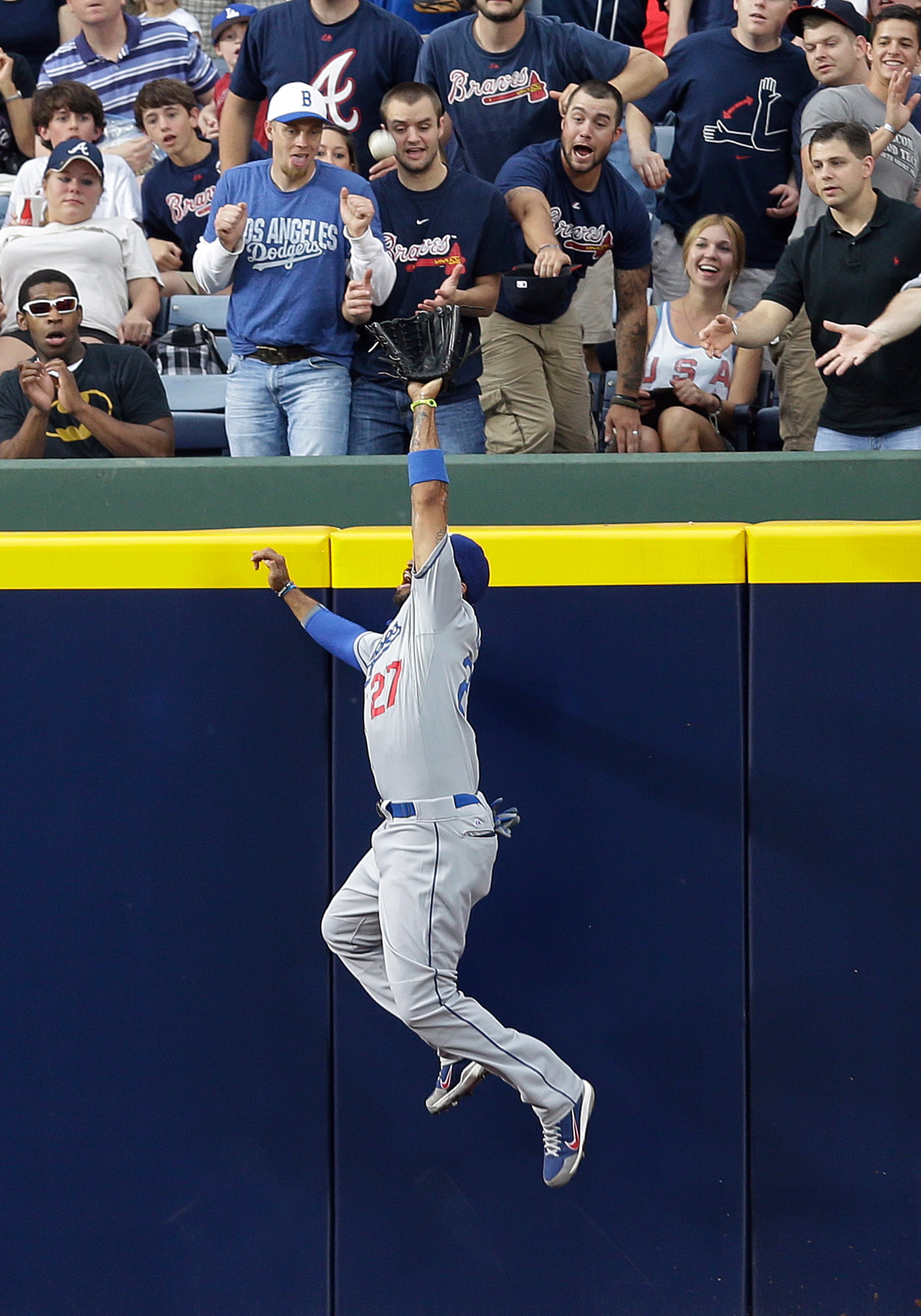 Dodgers center fielder Matt Kemp (27) makes a leaping catch to rob Atlanta's' Jason Heyward of a home run in the second inning.