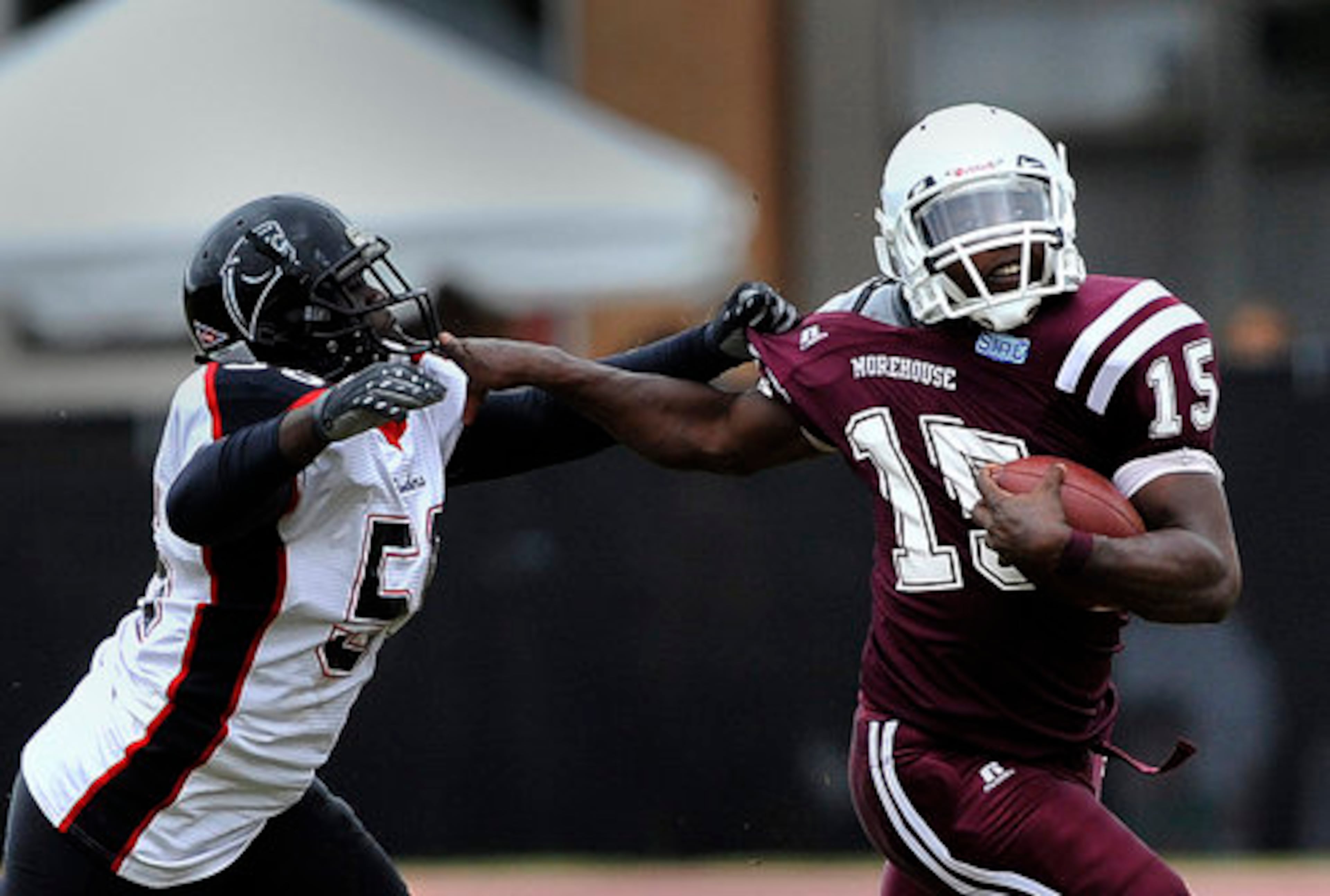Morehouse quarterback William Brack fights to get away from Clark Atlanta's William Hollis during Saturday's game between the Atlanta University Center rivals.