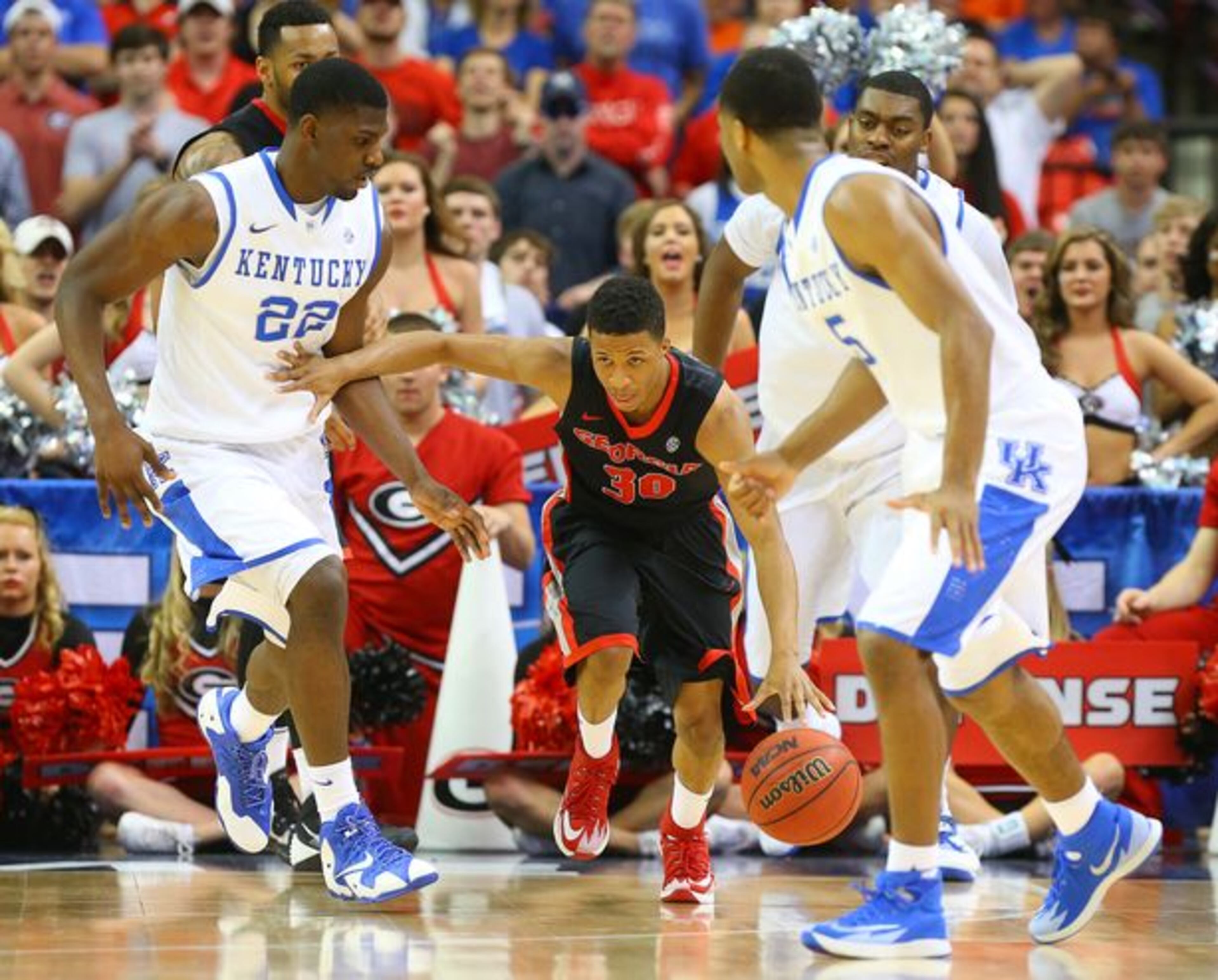 J.J. Frazier tries to navigate among Wildcats. (Curtis Compton/AJC)
