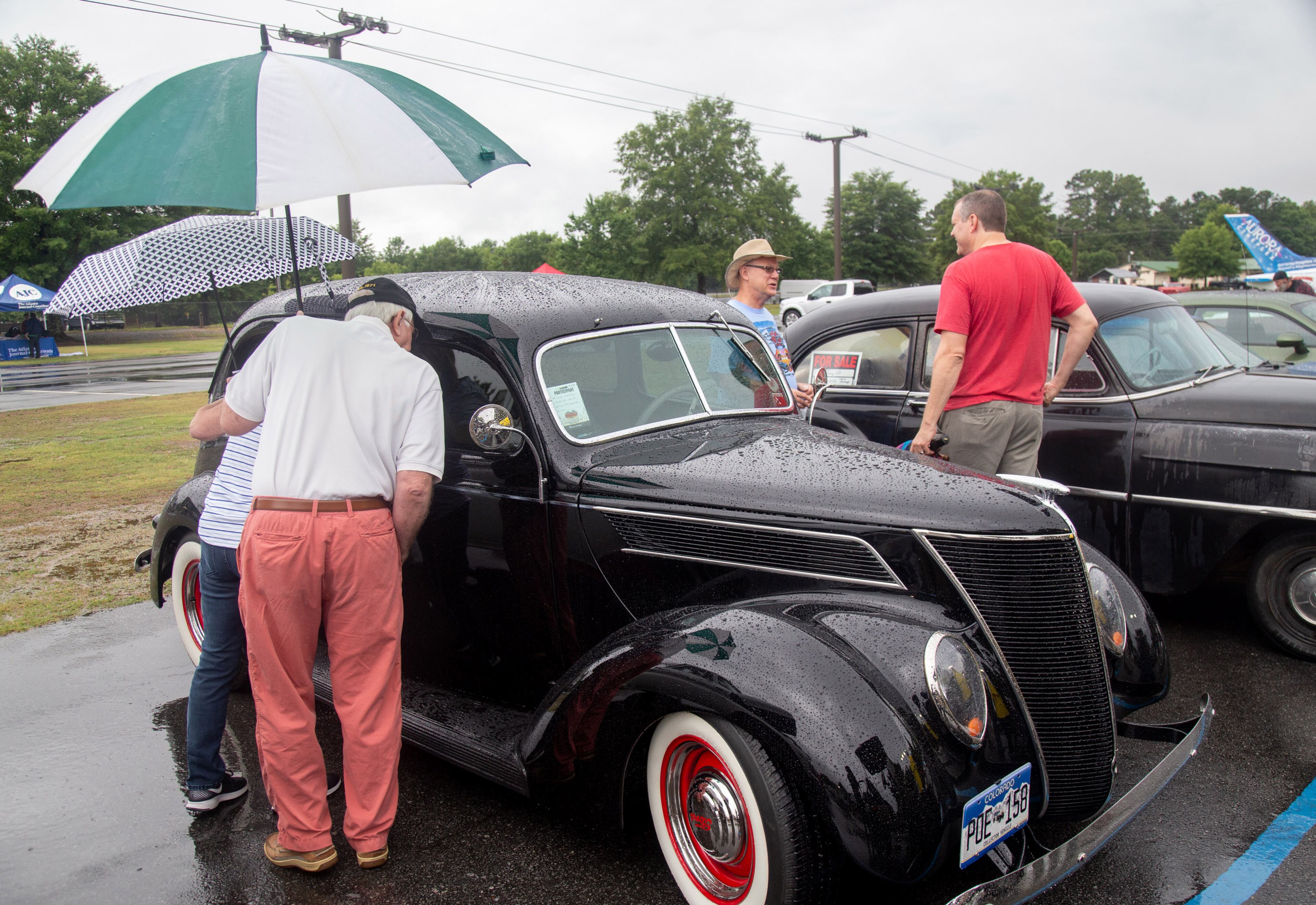 People look over a 1937 Ford during the Creepers Car Club’s 29th annual charity show, also referred to as Creepers' Car Club Fun Run #29 in Marietta on Saturday, June 8, 2019. STEVE SCHAEFER / SPECIAL TO THE AJC