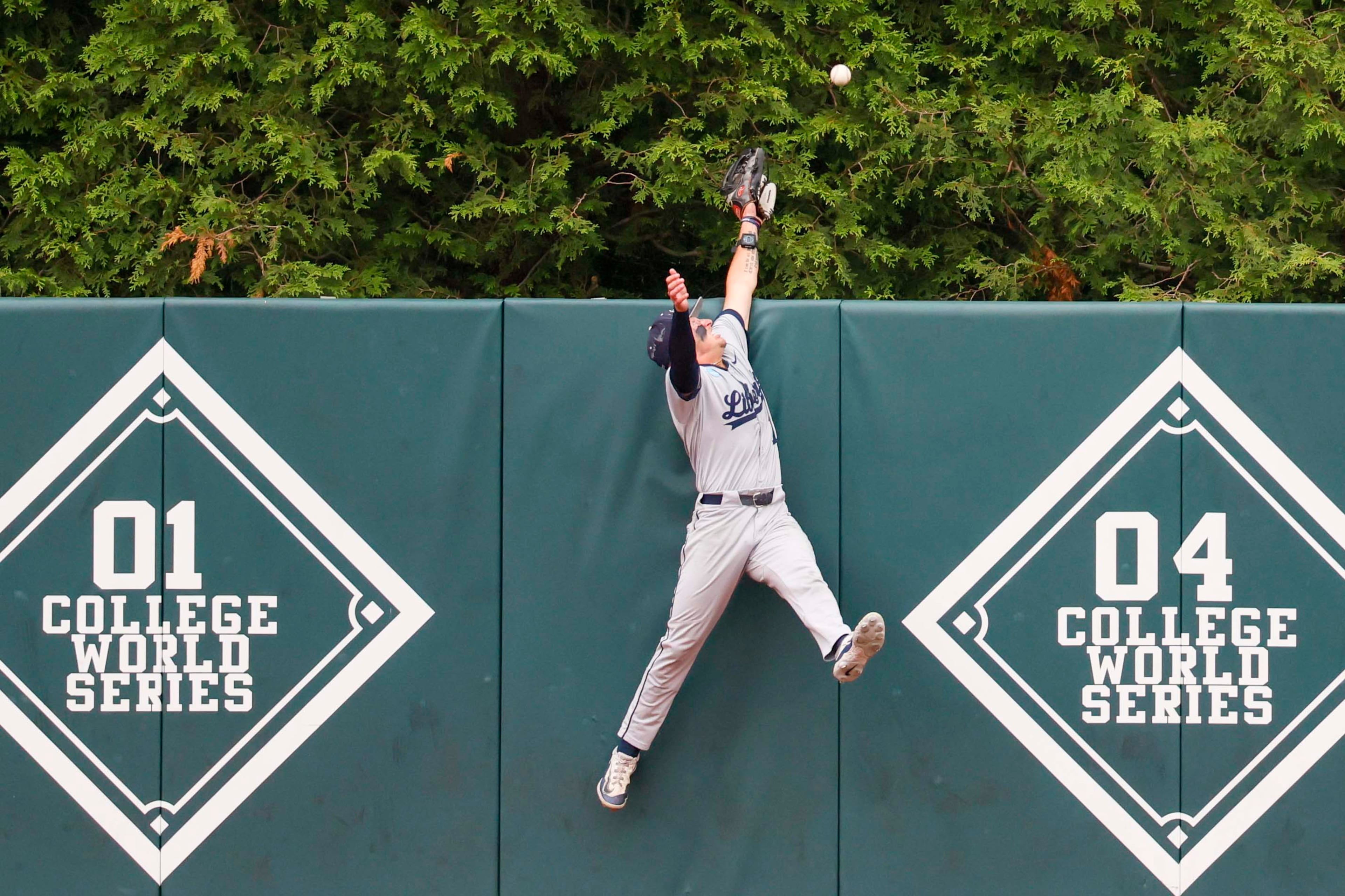 Liberty Flames outfielder Nick Barone cannot catch the ball from Georgia Bulldogs infielder Tre Phelps during a two-run home run in the sixth inning of their NCAA Regional final game at Foley Field on Sunday, May 31, 2026, in Athens. (Miguel Martinez/AJC)