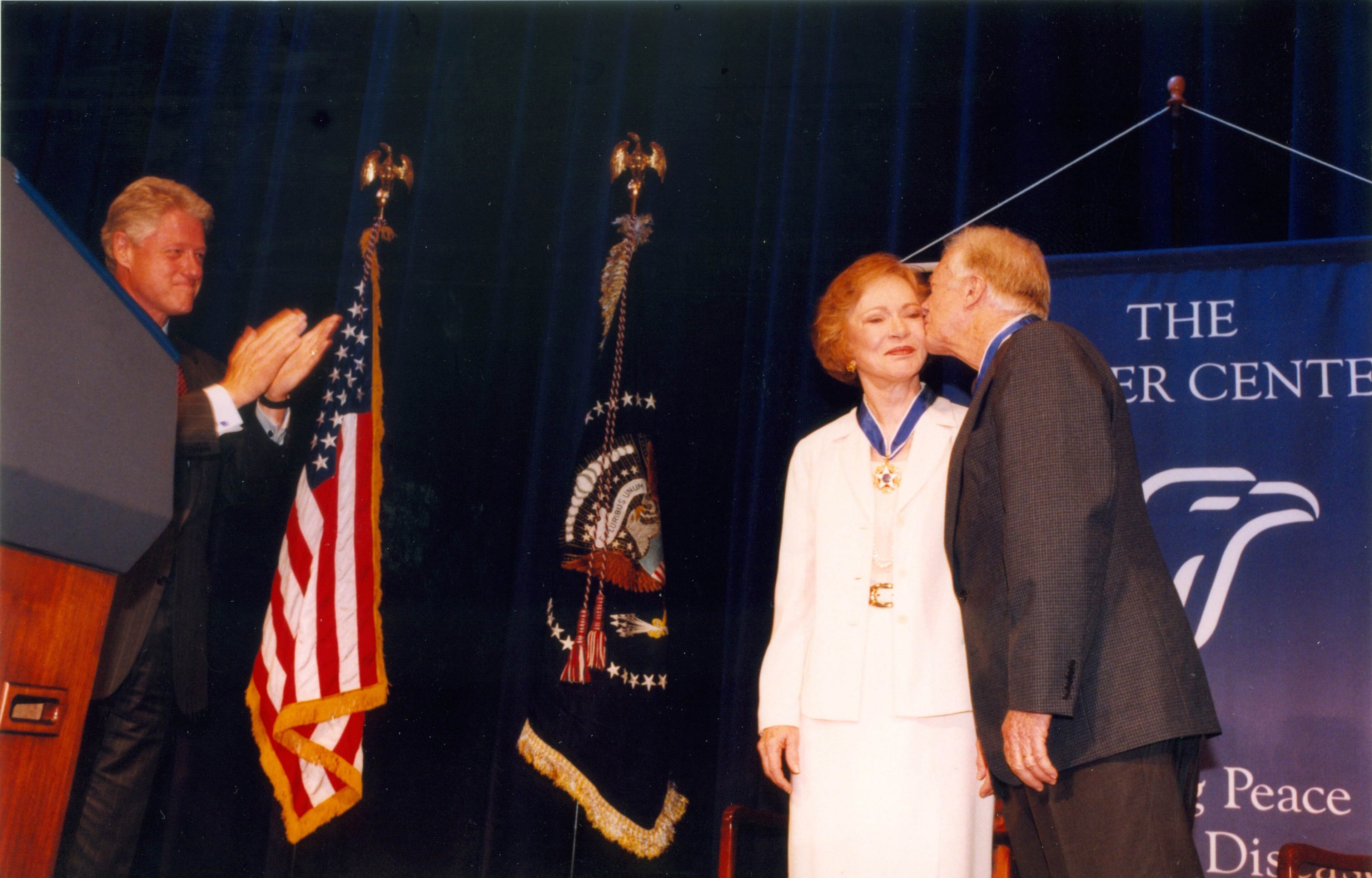 Former President Jimmy Carter and former First Lady Rosalynn Carter receive the Presidential Medal of Freedom from President Bill Clinton at a ceremony at The Carter Center in Atlanta Aug. 9, 1999. (The Carter Center)
26.