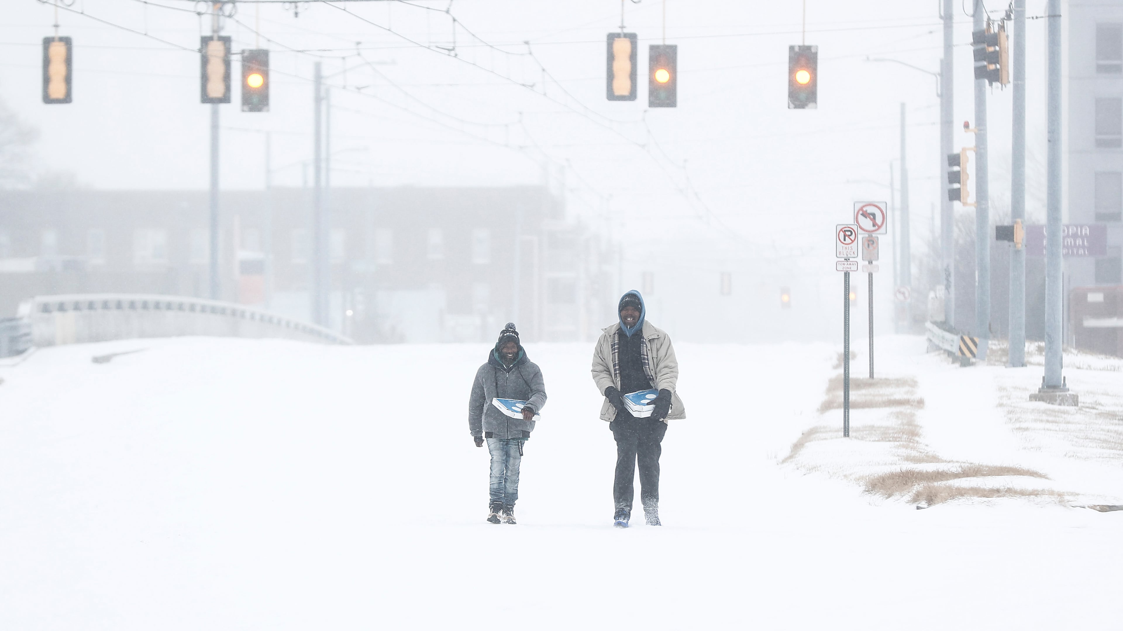 Jimmy Jordan, left, and Cordarol Dale walk through snow in Memphis, Tenn., Saturday, Jan. 24, 2026. (Mark Weber/Daily Memphian via AP)