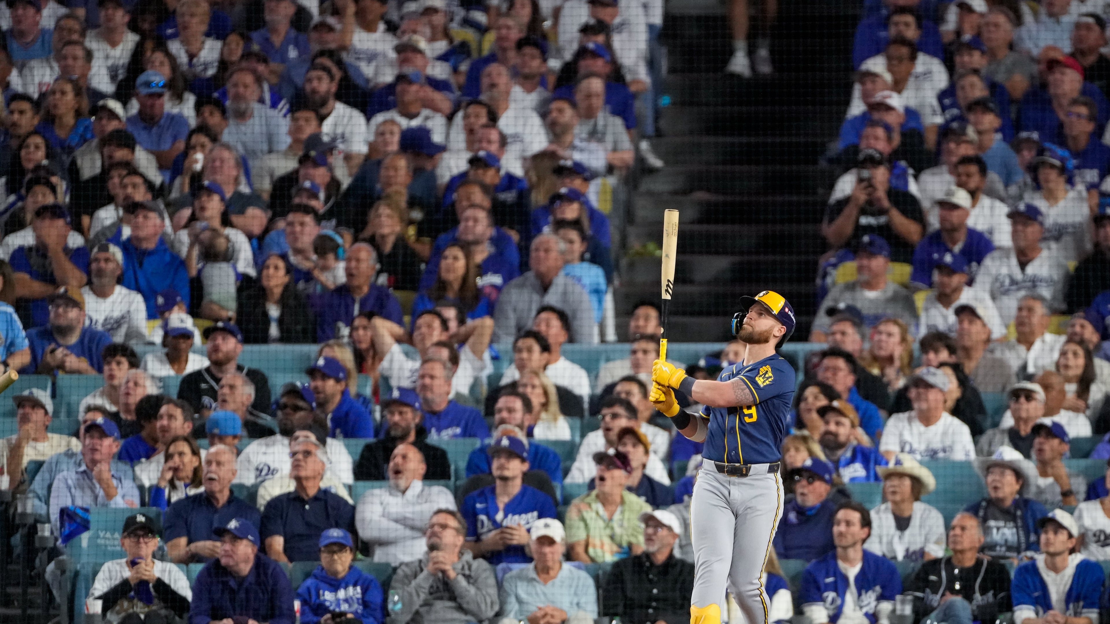 Milwaukee Brewers first baseman Jake Bauers watches his two RBI home run leave the park during the seventh inning of Game 3 of baseball's National League Championship Series between the Milwaukee Brewers and the Los Angeles Dodgers, Wednesday, Oct. 14, 2026, in Los Angeles. (AP Photo/Mark J. Terrill)