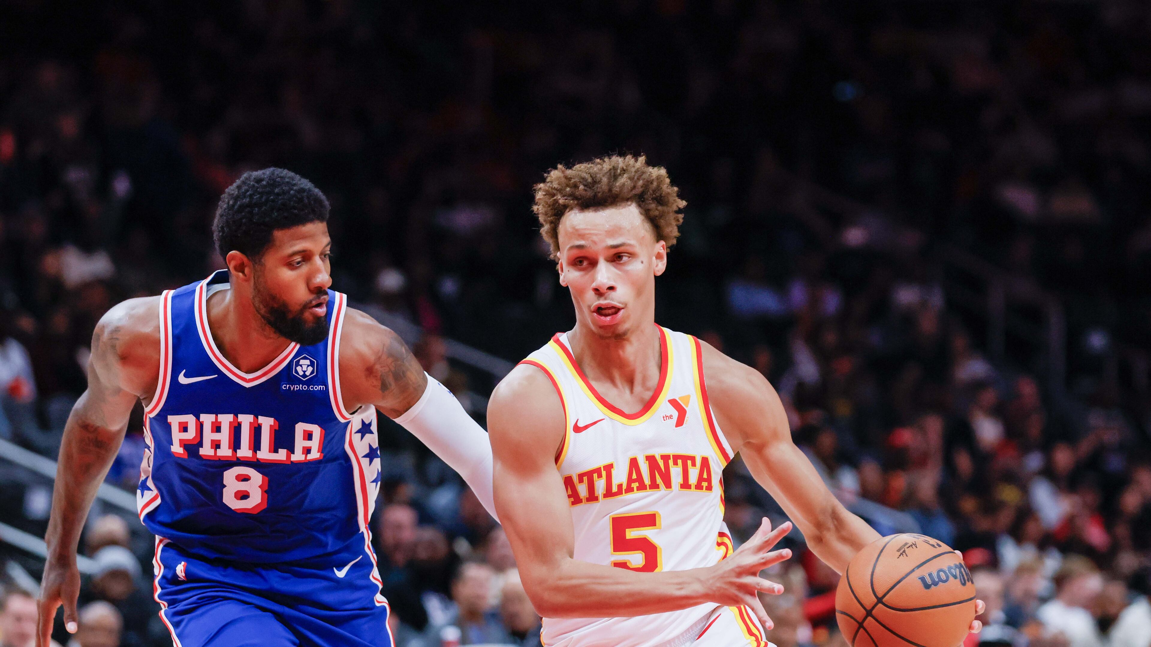 Atlanta Hawks guard Dyson Daniels (5) dribbles against Philadelphia 76ers forward Paul George (8) during the first half at State Farm Arena during an NBA exhibition game on Monday, October 14, 2024, in Atlanta. (Miguel Martinez/ AJC)