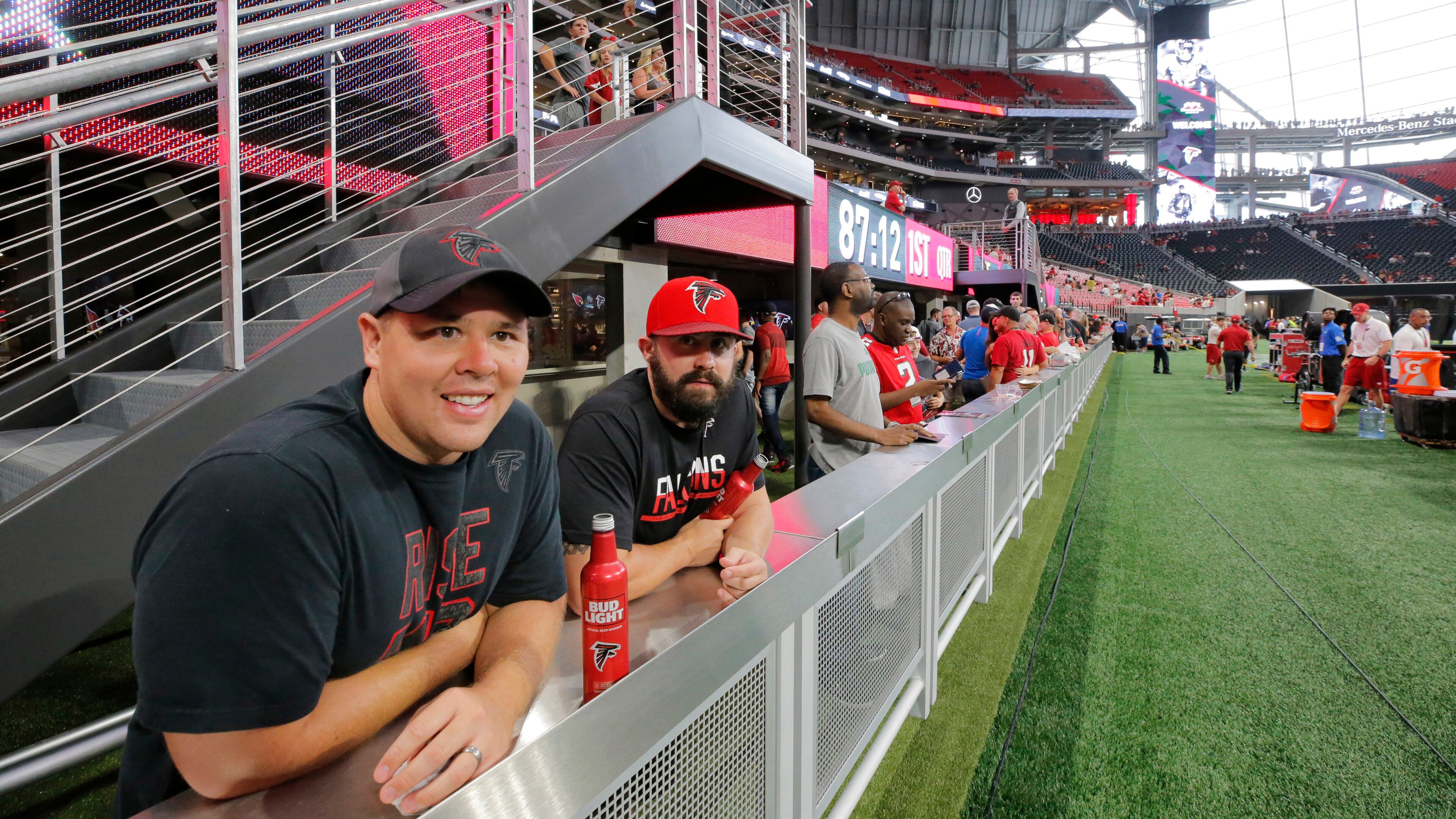 Chris Nguyen (left) and Lance Durden, from Augusta, take in the view from field level before the first game at Mercedes-Benz Stadium, an exhibition game against the Arizona Cardinals on Saturday, Aug. 26, 2017, in Atlanta.