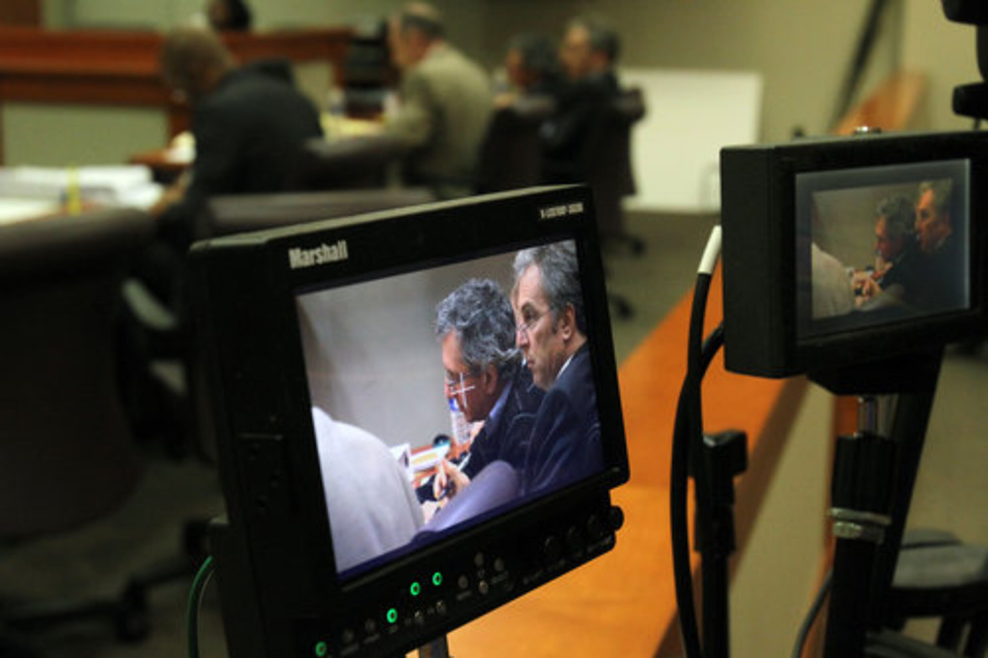 Sitting next to Neuman and shown in this video screen is attorney Bob Rubin.