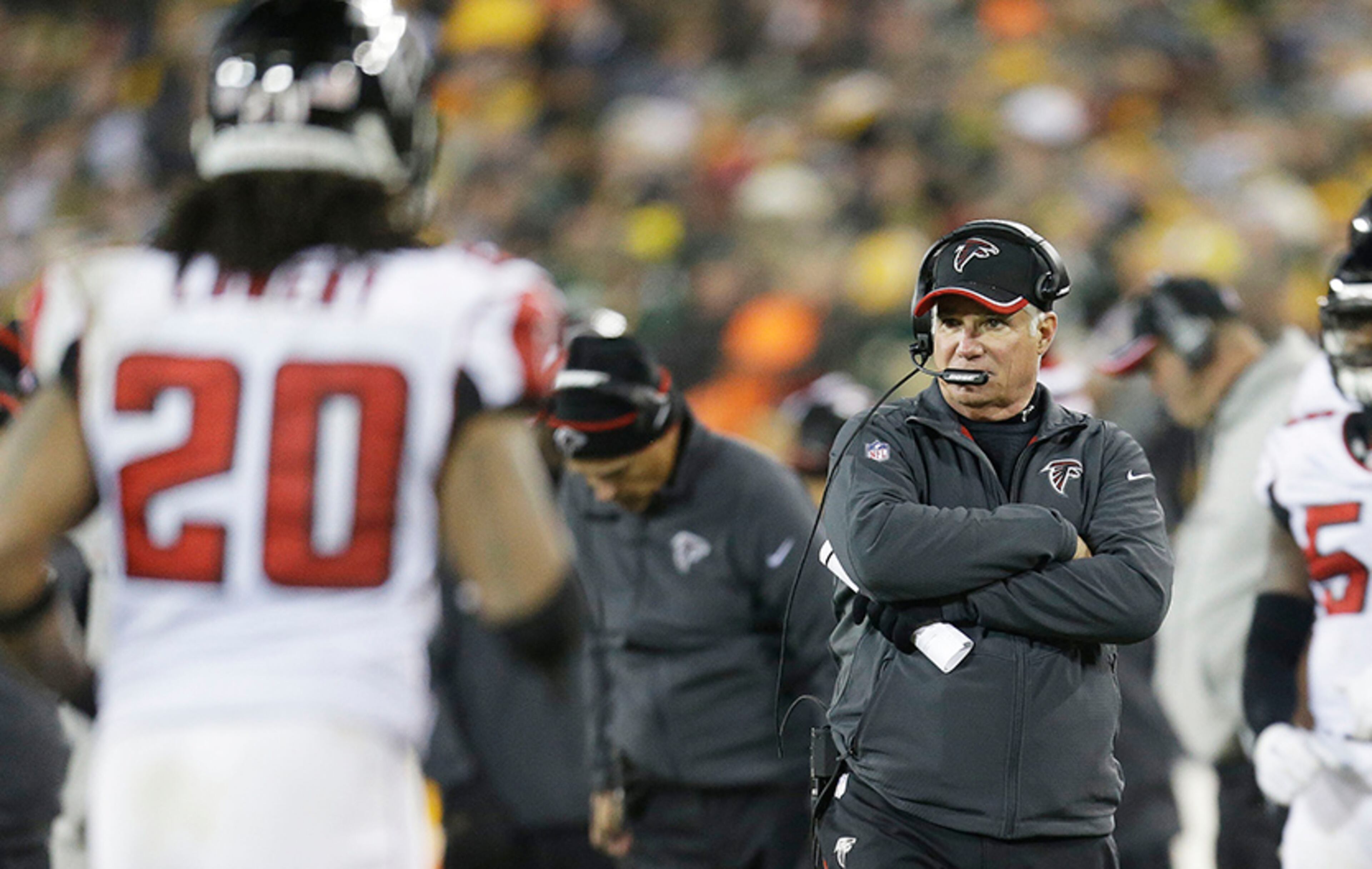 Falons head coach Mike Smith evaluates his team during the second quarter against the Green Bay Packers at Lambeau Field on Dec. 8, 2014, in Green Bay, Wis.