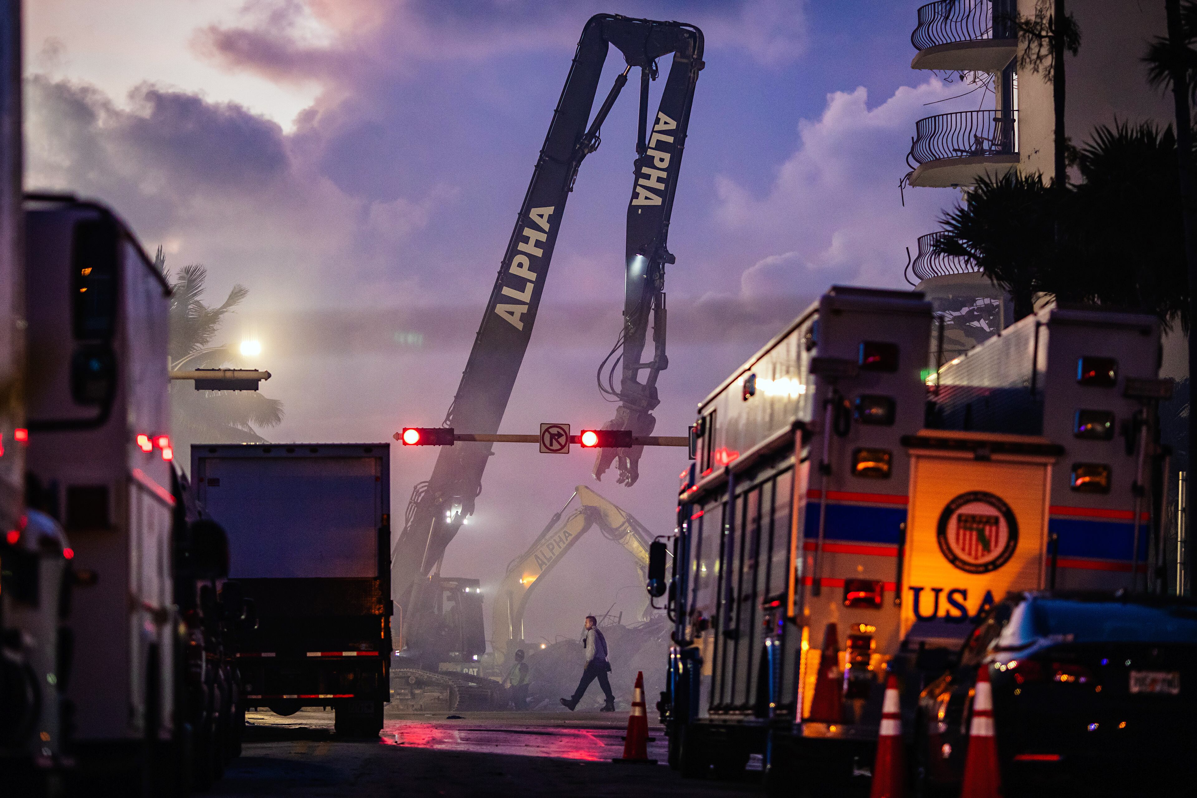Members of the Miami-Dade Fire Rescue team and excavation crews work to remove debris and continue the search efforts at the Champlain South Towers in Surfside, Fla., on Saturday, June 26, 2021. Some who recall the early days following the World Trade Center catastrophe say the reports and images from Florida are almost too familiar. (Scott McIntyre/The New York Times)