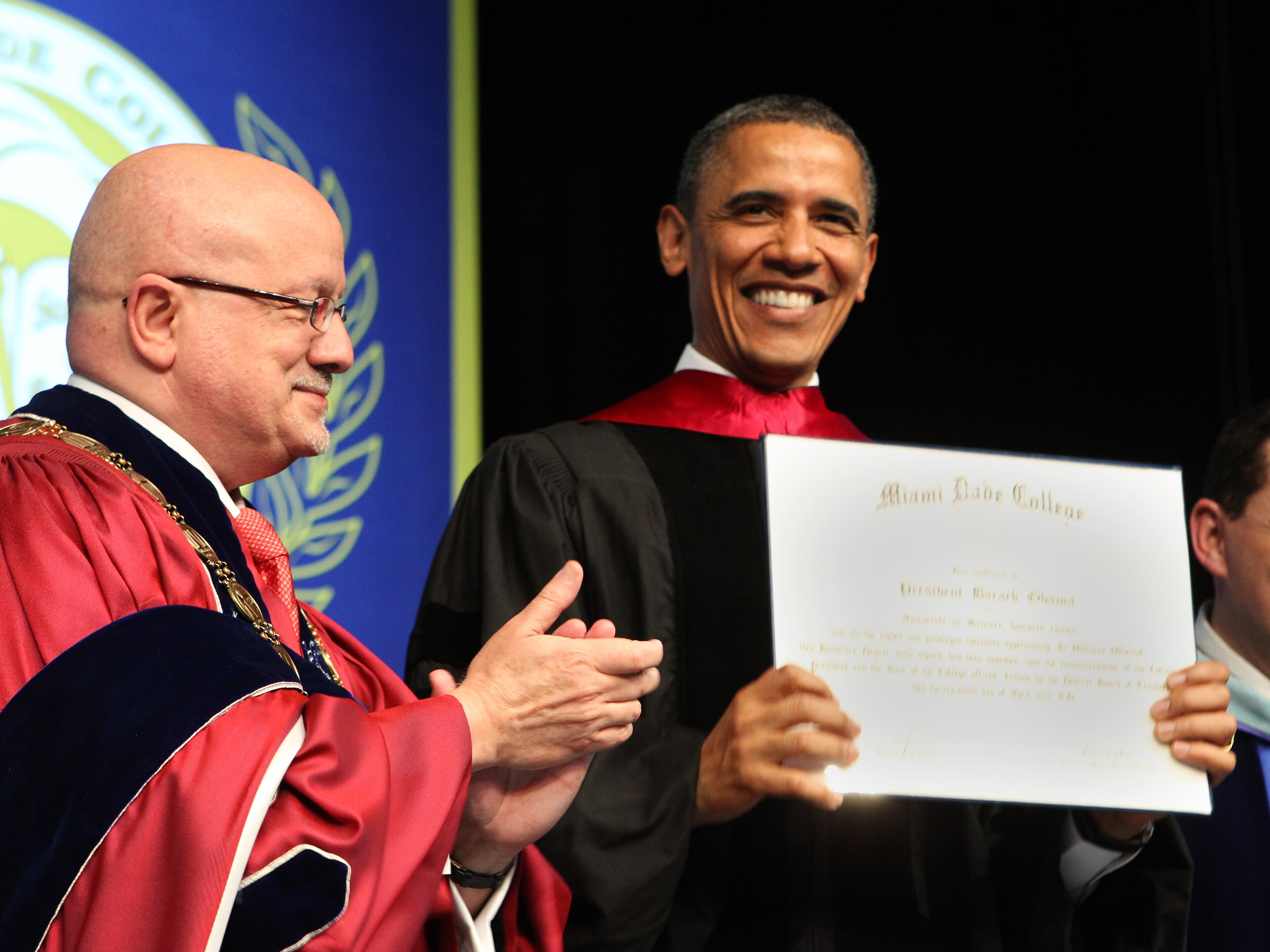 U.S. President Barack Obama (R) is congratulated by Dr. Jose A. Vicente, president of Miami Dade College, after receiving an honorary degree April 29, 2011 at Miami Dade College in Miami, Florida. The president delivered the commencement address. (Photo by Robert Sullivan-Pool/Getty Images)