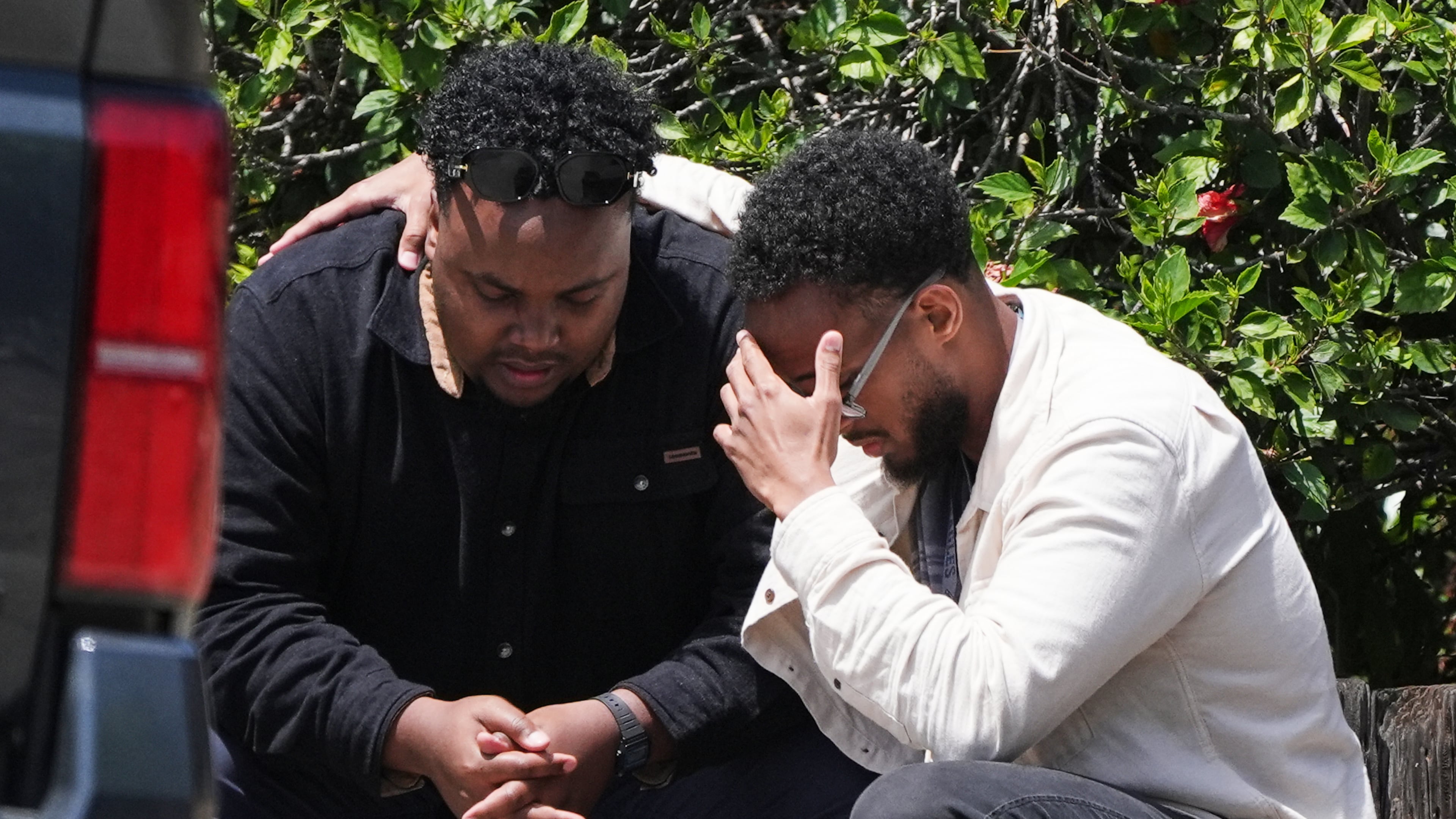 Two men embrace at the scene of a shooting outside the Islamic Center of San Diego Monday, May 18, 2026, in San Diego. (AP Photo/Gregory Bull)
