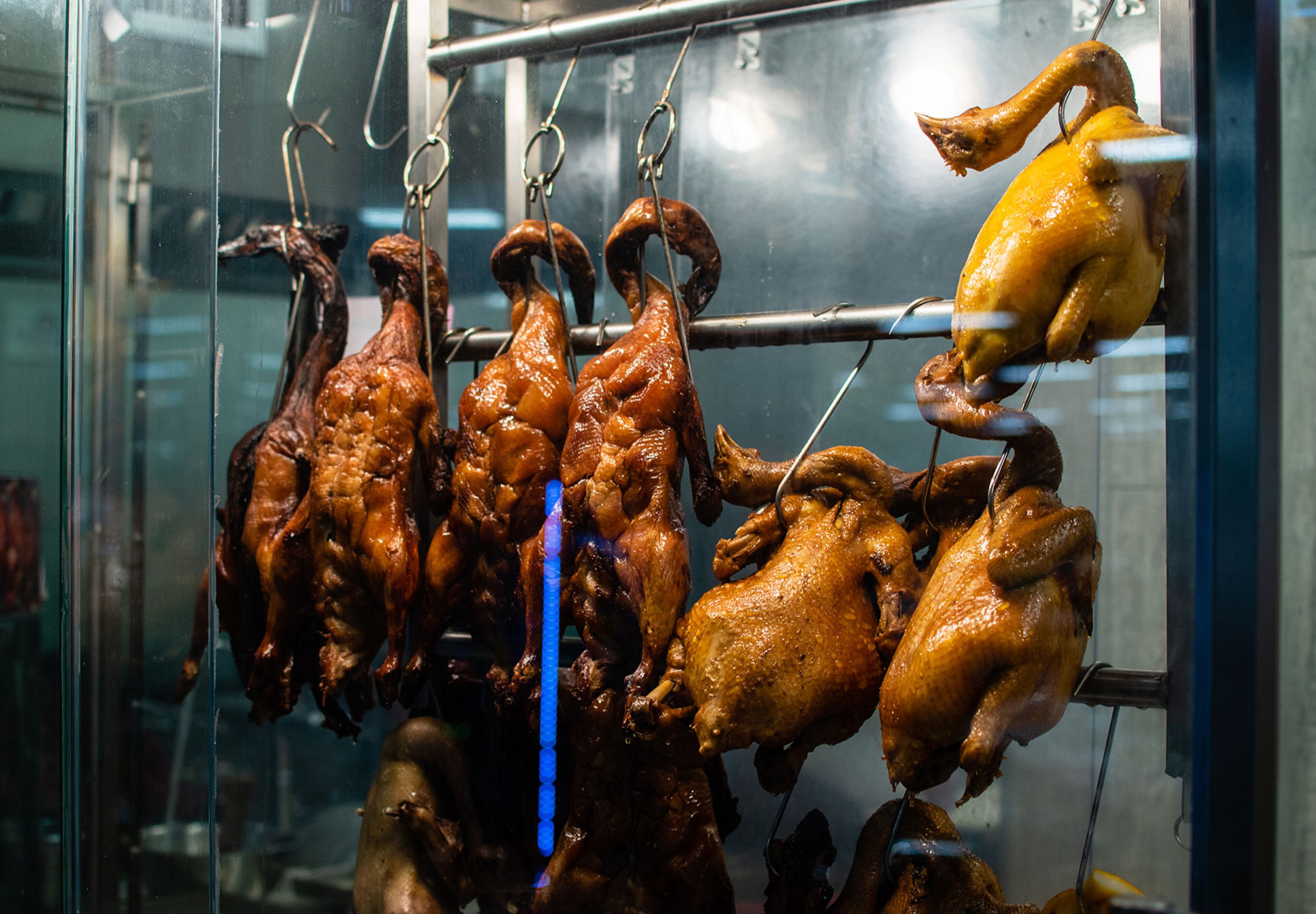 Barbecued poultry hang right at the counter at BBQ Corner in Jusgo Food Court.