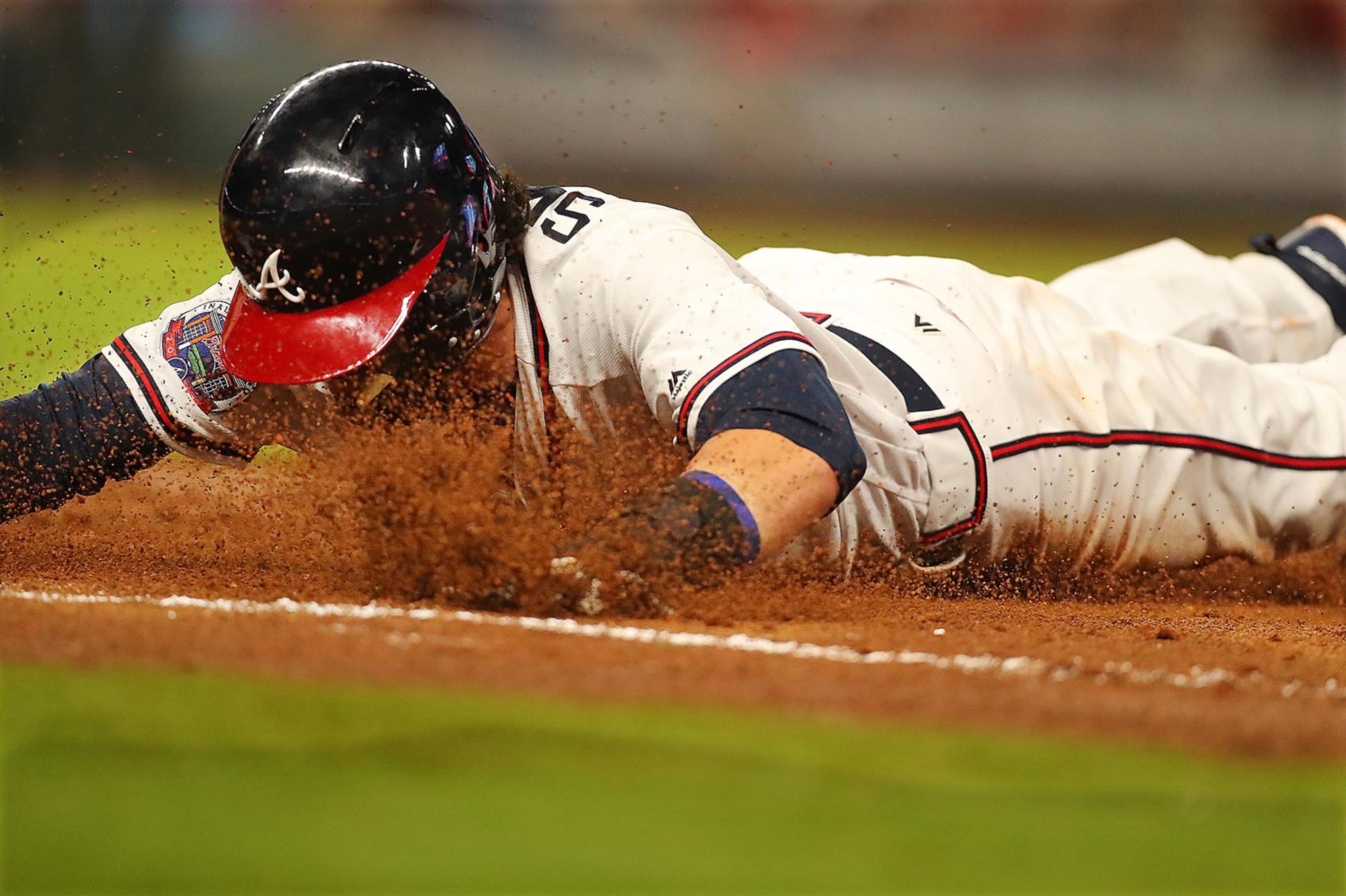 April 17, 2017, Atlanta: Braves Dansby Swanson gets a face full of dirt diving back to first safely on a pickoff attempt by Padres pitcher Jered Weaver during the third inning in a MLB baseball game on Monday, April 17, 2017, in Atlanta. Curtis Compton/ccompton@ajc.com