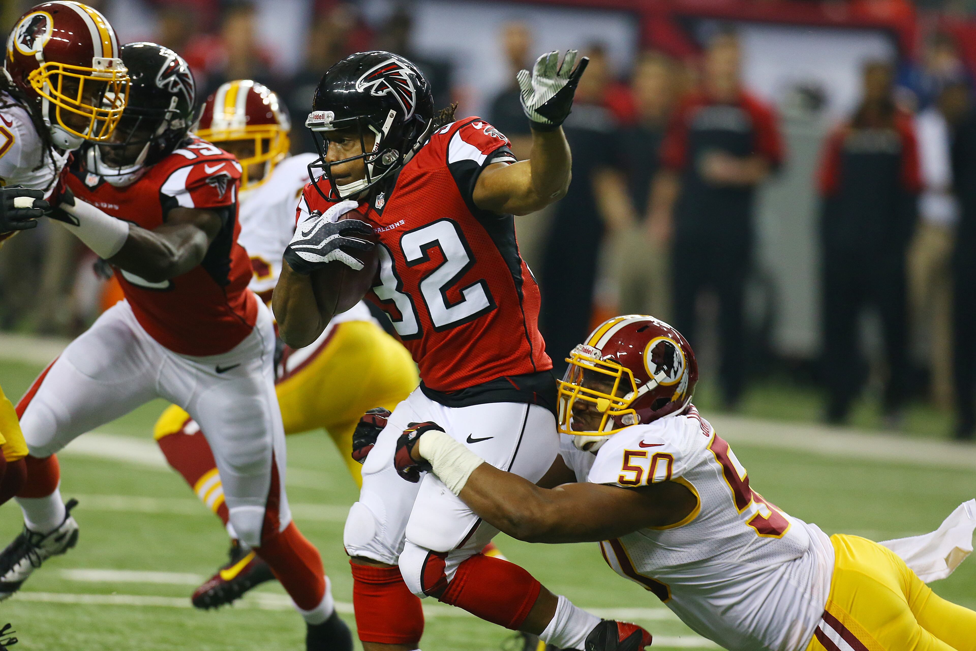 Falcons running back Jacquizz Rodgers is brought down by Redskins linebacker Rob Jackson on a kickoff return for yardage during 1st half action in a NFL football game on Sunday, Dec. 15, 2013, in Atlanta.
