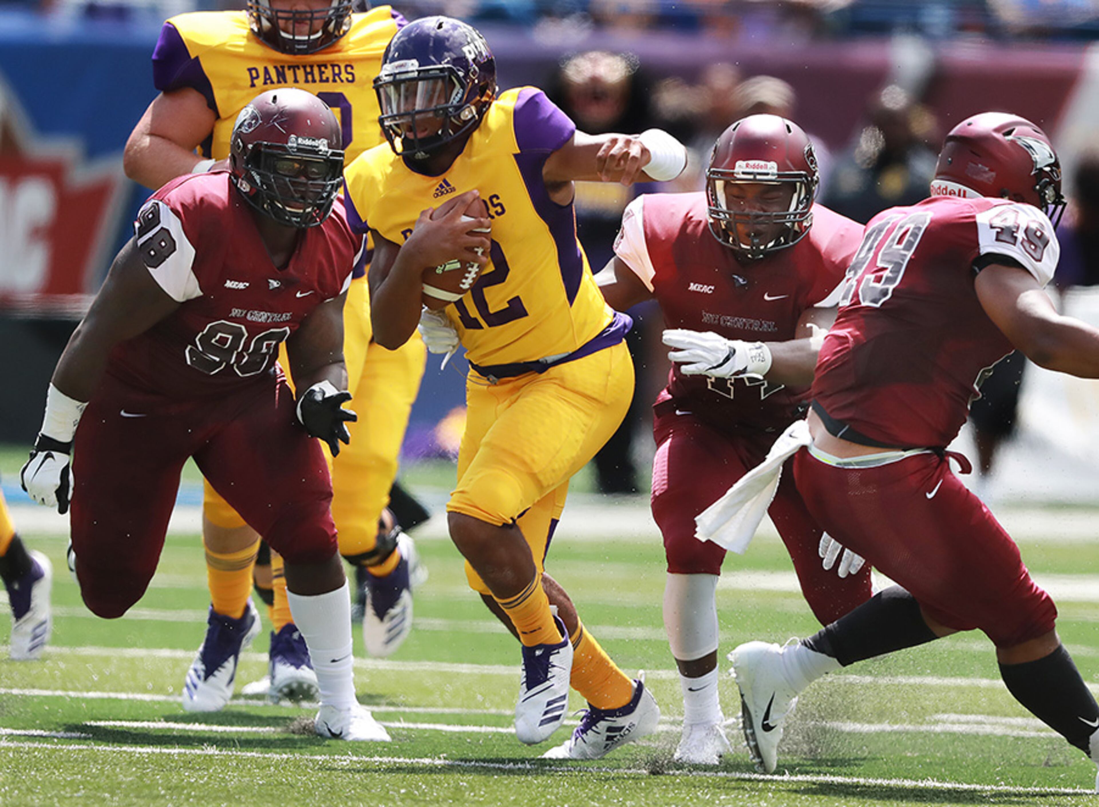 Prairie View A&M quarterback Jalen Morten runs past three North Carolina Central defenders for a first down during the first half of the MEAC-SWAC Challenge Sunday, Sept. 2, 2018, in Atlanta.