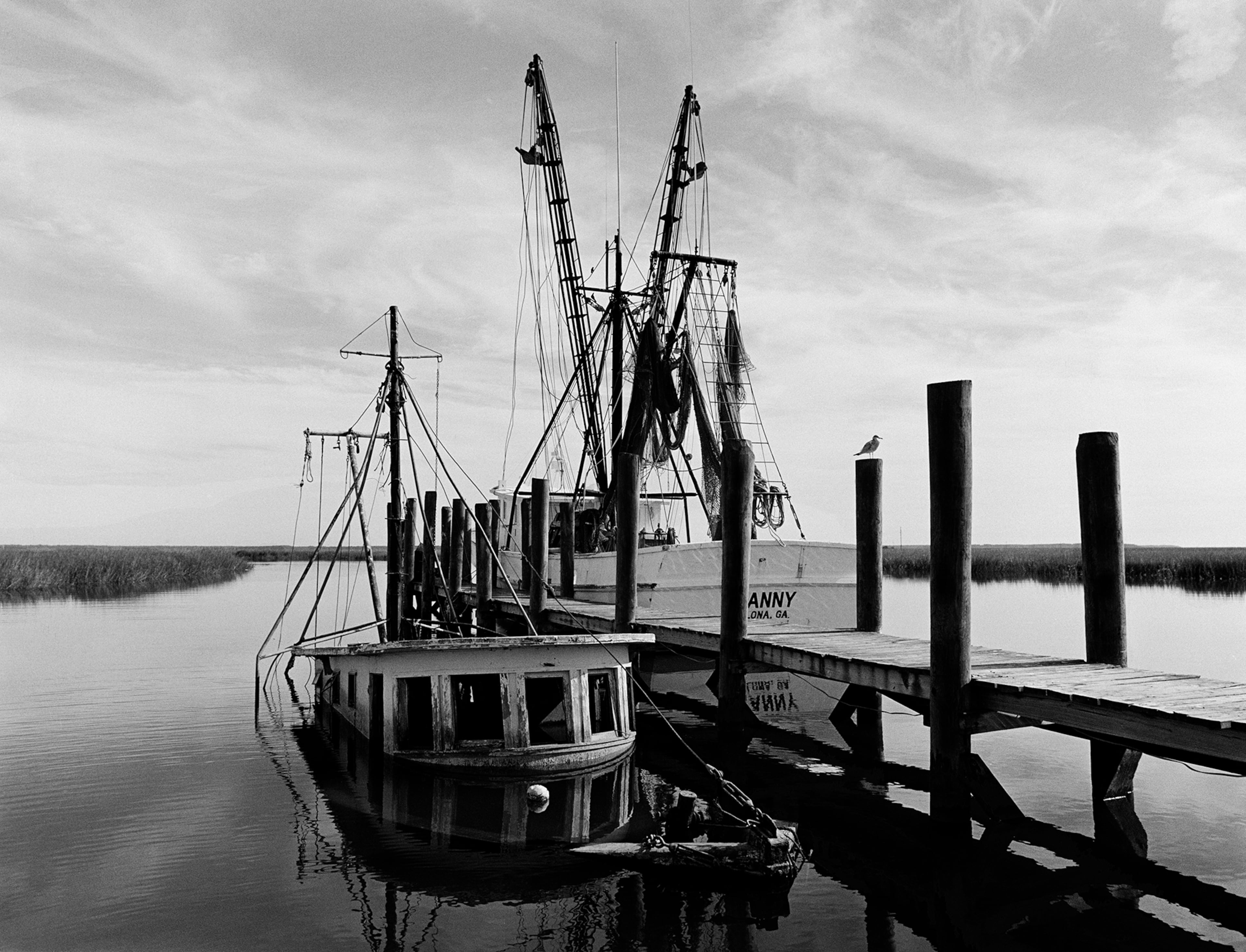 "Sunken Shrimp Boat," a 1987 photograph by Jack Leigh. Photos of Georgia's coast by Leigh and Parker Stewart are on display at Laney Contemporary, a Savannah gallery, until Aug. 1, 2026. (Courtesy of Jack Leigh/Laney Contemporary)