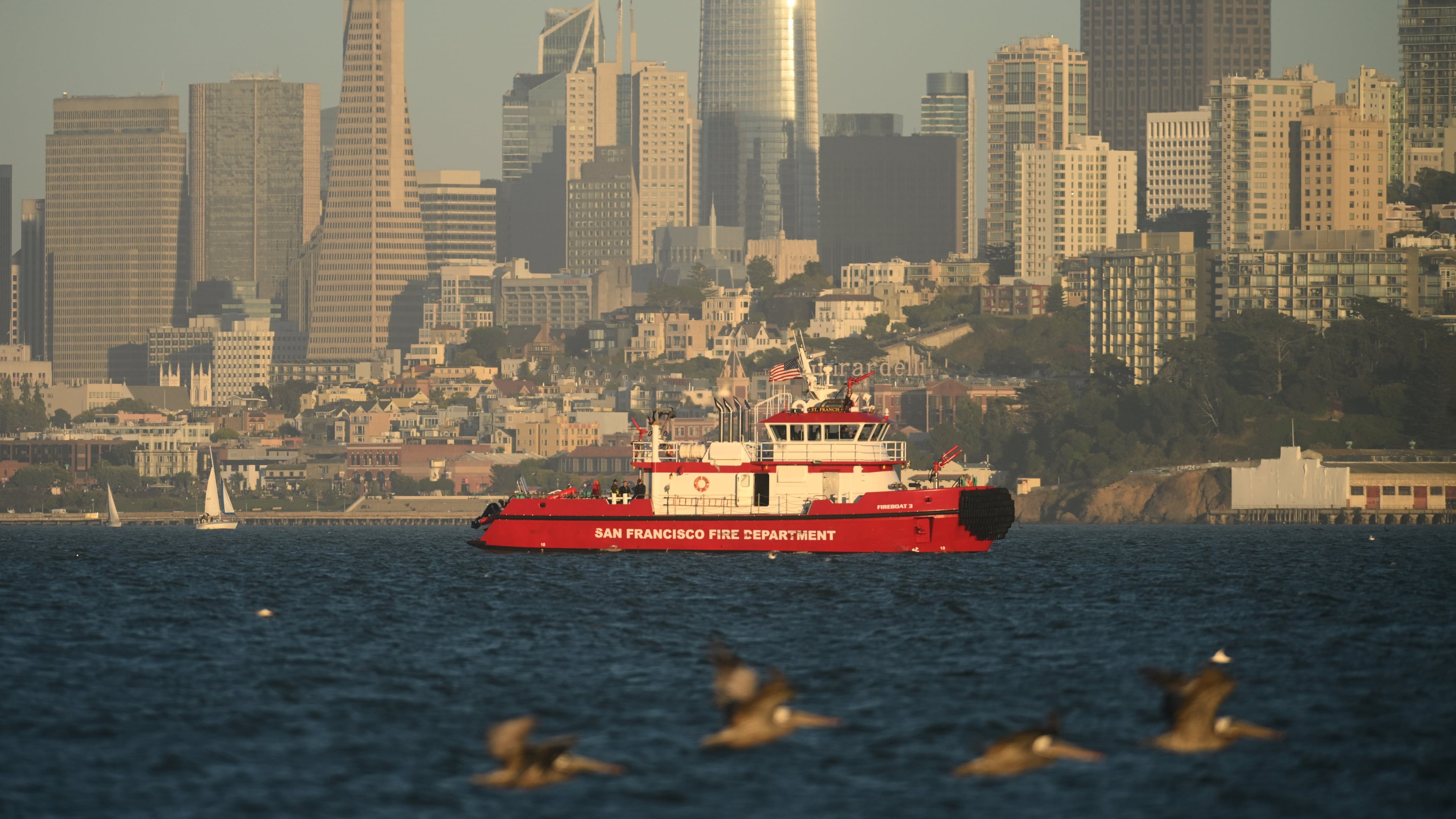 A San Francisco Fire Department vessel passes the city skyline while searching for missing victims after a boat accident near Alcatraz Island off San Francisco, Tuesday, July 14, 2026. (AP Photo/Noah Berger)