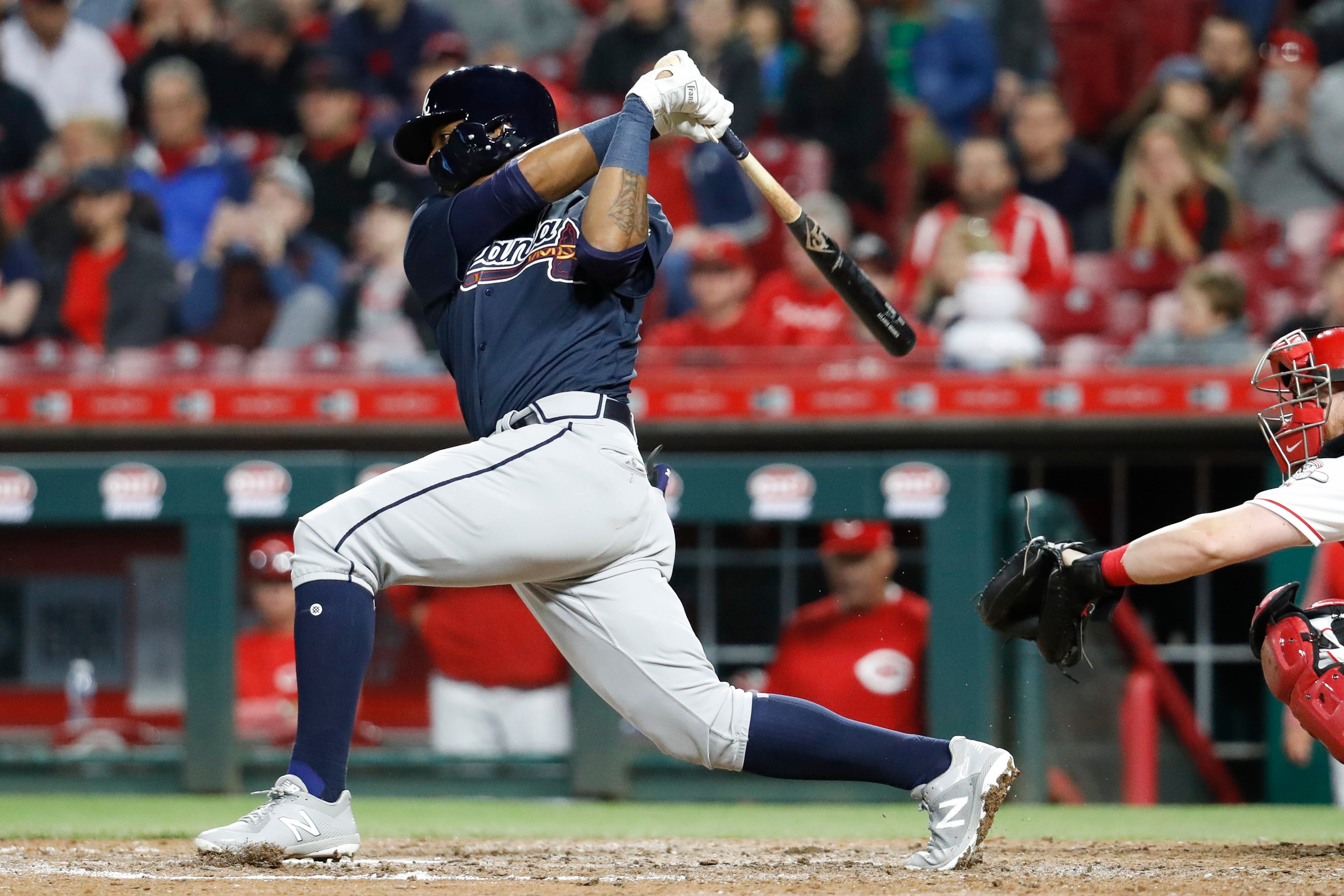 Atlanta Braves' Ronald Acuna Jr. follows through on a single off Cincinnati Reds relief pitcher Kevin Shackelford during the eighth inning of a baseball game Wednesday, April 25, 2018, in Cincinnati. (AP Photo/John Minchillo)