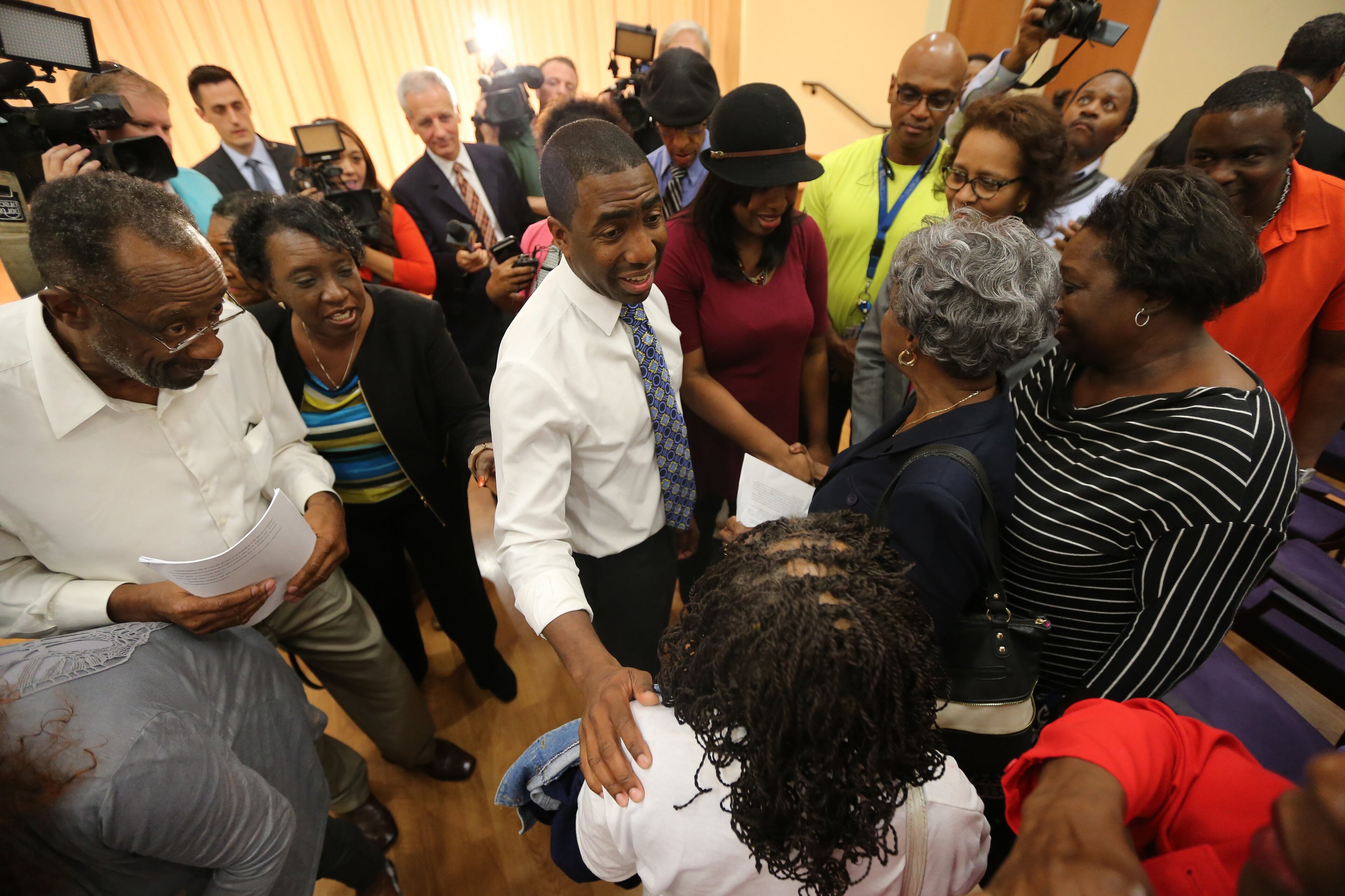 October 13, 2015 Lithonia: Residents greet interim DeKalb County CEO Lee May following a Tuesday evening October 13, 2015 forum at the Lou Walker Senior Center in Lithonia. Ben Gray / bgray@ajc.com