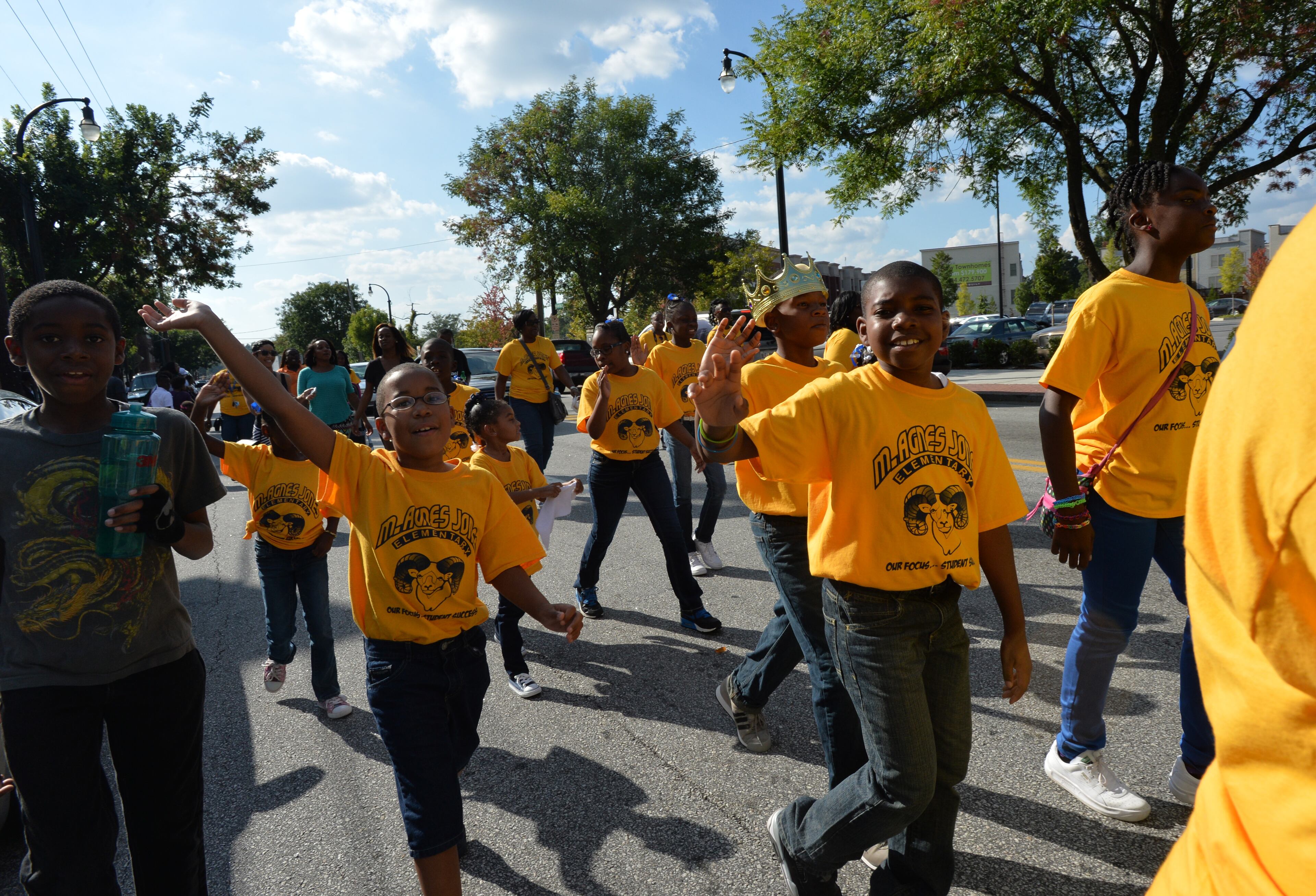 Students from M. Agnes Jones Elementary march during the parade featuring superintendent Meria J. Carstarphen, Washington alumni and students on Martin Luther King, Jr. Drive on Saturday, September 20, 2014. Washington High School opened in 1924 as the first public high school for African-Americans in Georgia.