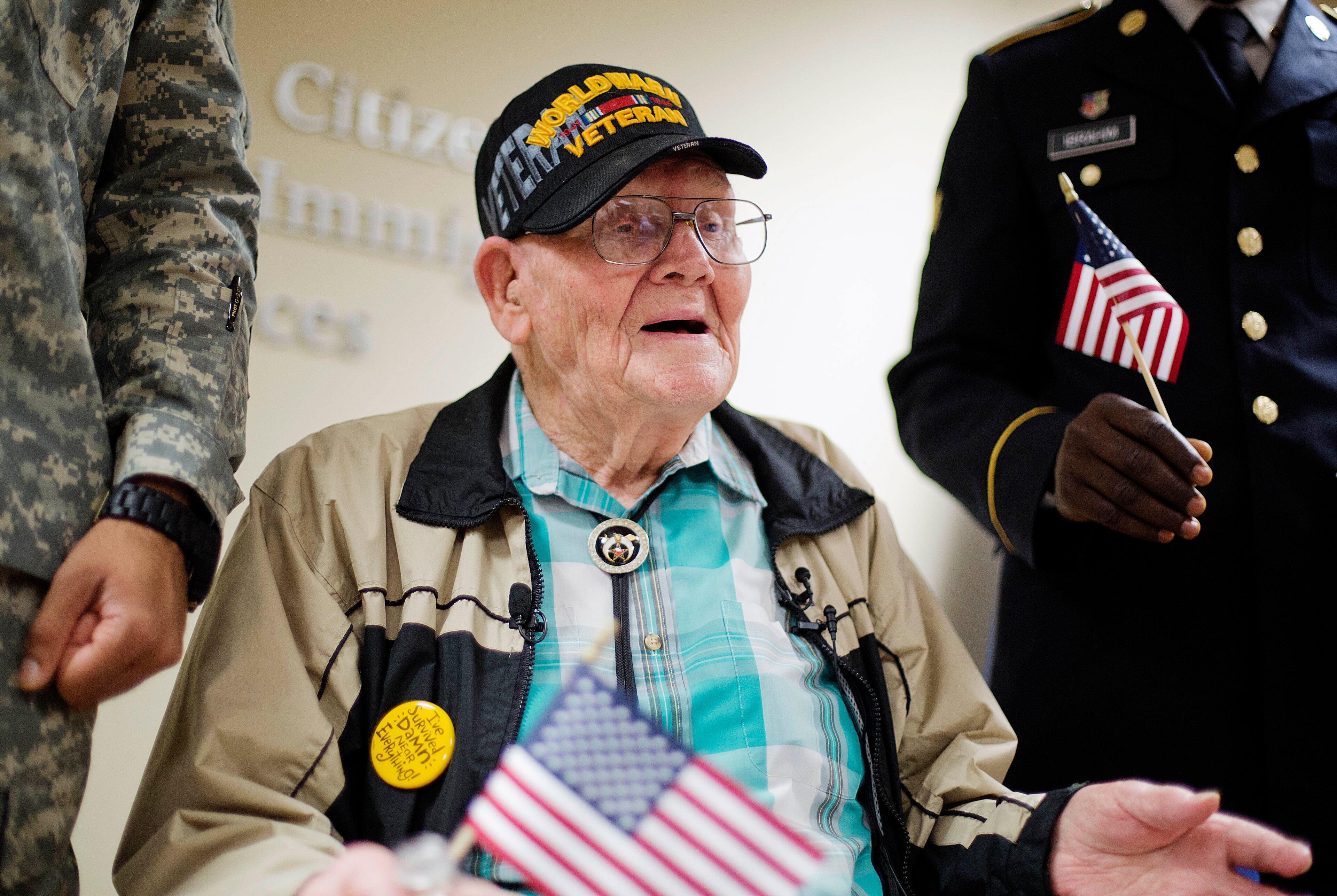 Ninety-four-year-old World War II veteran Sherwin Callander talks to the media after a naturalization ceremony Monday, June 2, 2014, in Atlanta.