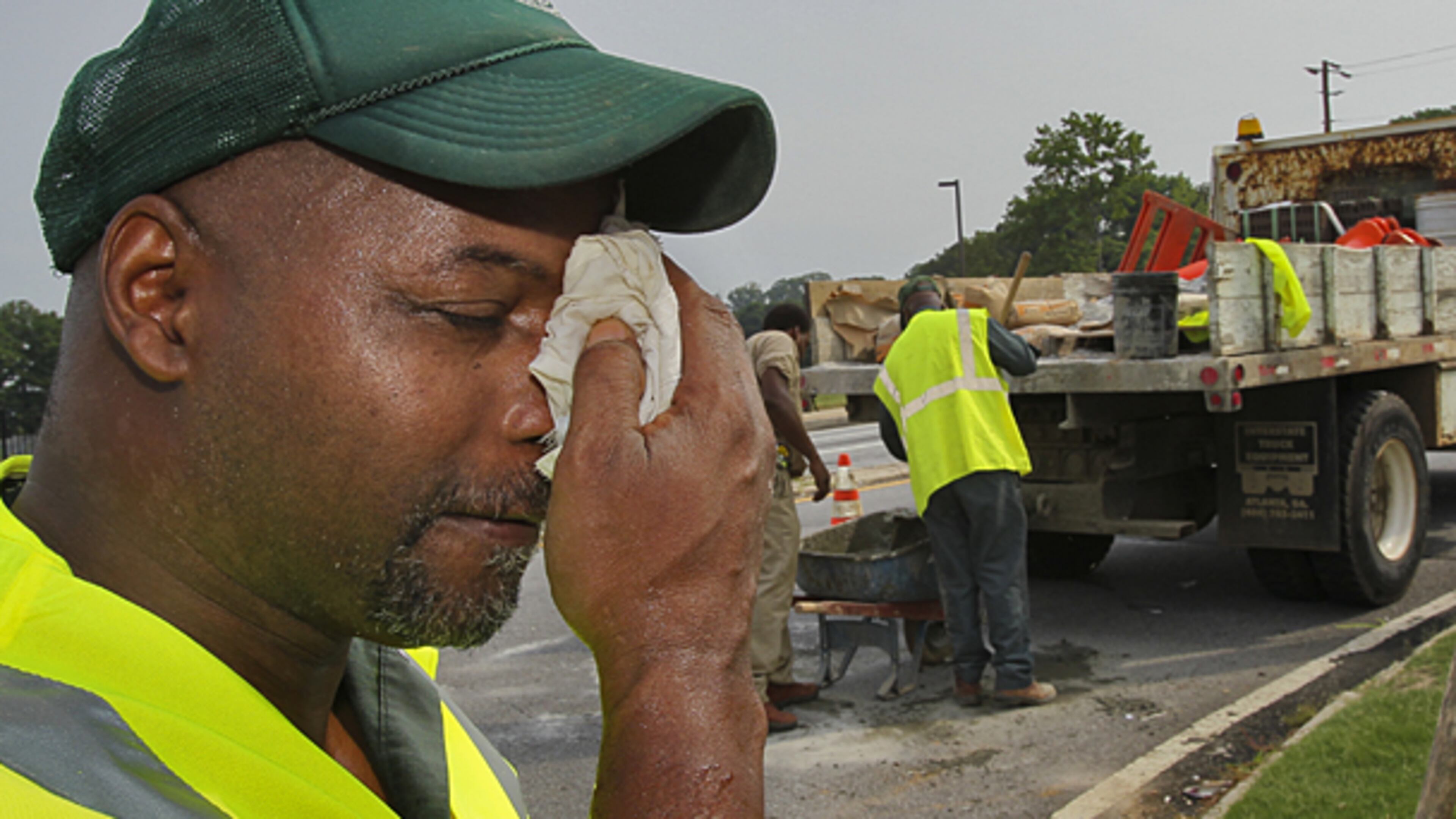 With a heat advisory and heat index topping 100 degrees, Gregory Merchinson, part of a crew with DeKalb County Roads and Drainage, worked at the corner of Briarcliff Road and North Druid Hills Road on a catch basin cave-in seal. There are currently no federal or state regulations specifically protecting outdoor workers from heat illness or death.