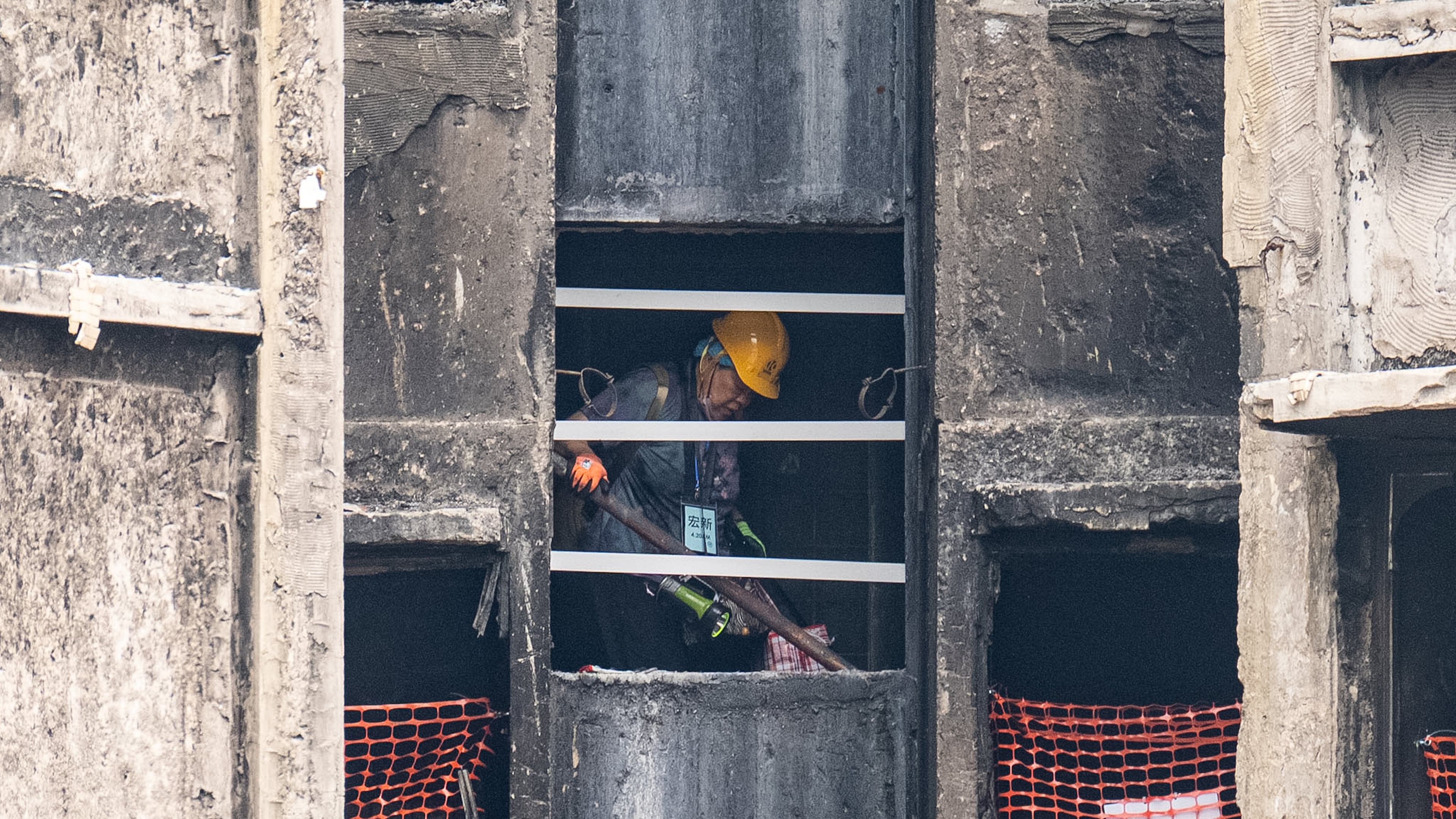 A resident of Wang Fuk Court retrieves belongings five months after the deadly fire in Hong Kong Monday, April 20, 2026. (AP Photo/Chan Long Hei)