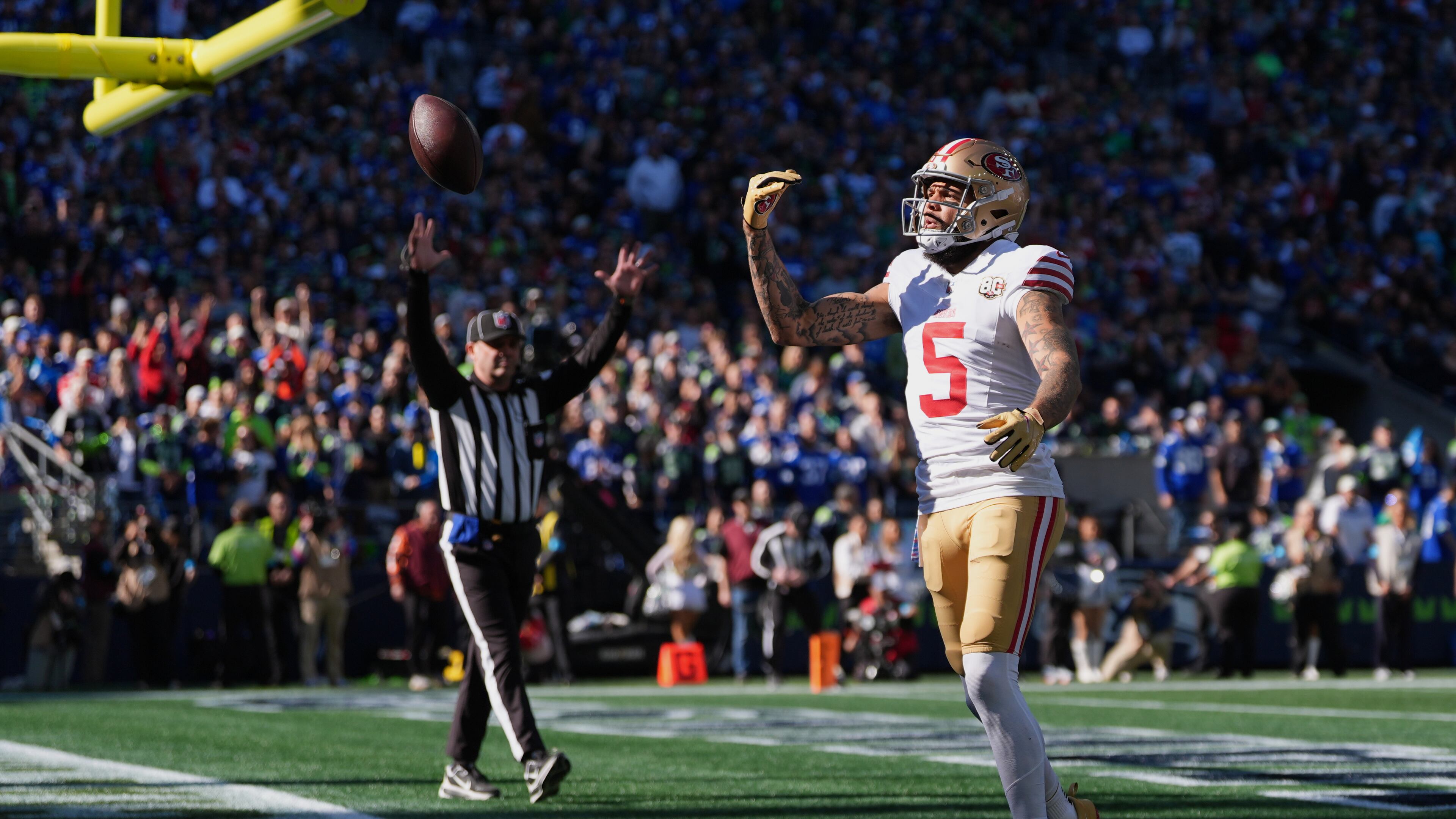 San Francisco 49ers wide receiver Mike Evans reacts after catching a touchdown pass from quarterback Brock Purdy during the first half of an NFL football game against the Seattle Seahawks, Sunday, Oct. 11, 2026, in Seattle. (AP Photo/Lindsey Wasson)