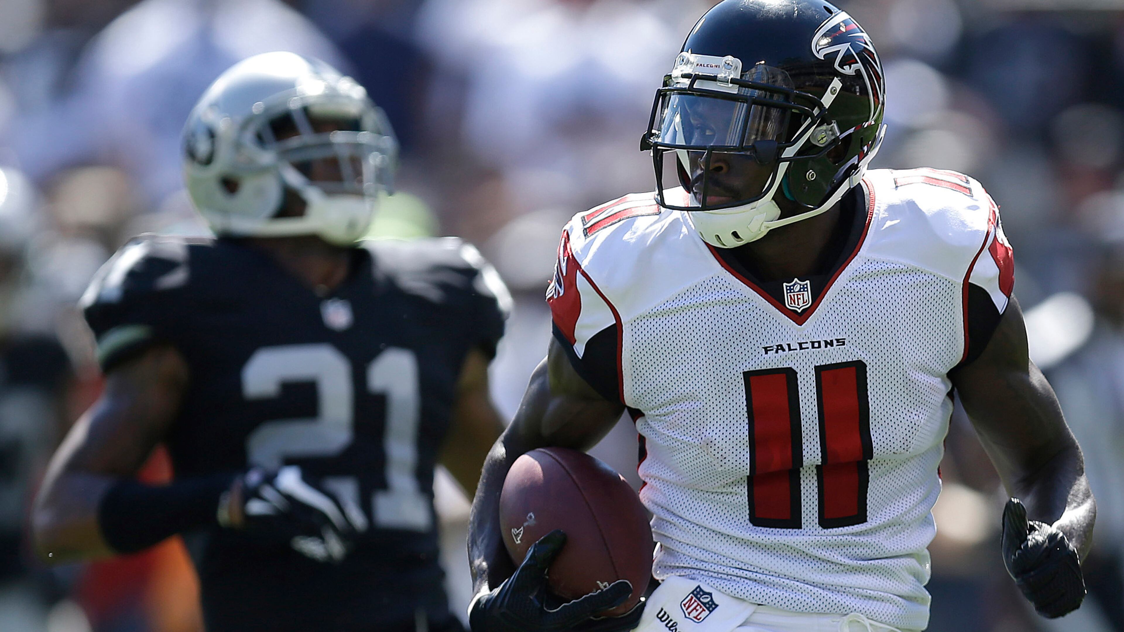Atlanta Falcons wide receiver Julio Jones (11) runs past Oakland Raiders cornerback Sean Smith (21) to score on a touchdown reception during the first half of an NFL football game in Oakland, Calif., Sunday, Sept. 18, 2016. (AP Photo/Ben Margot)