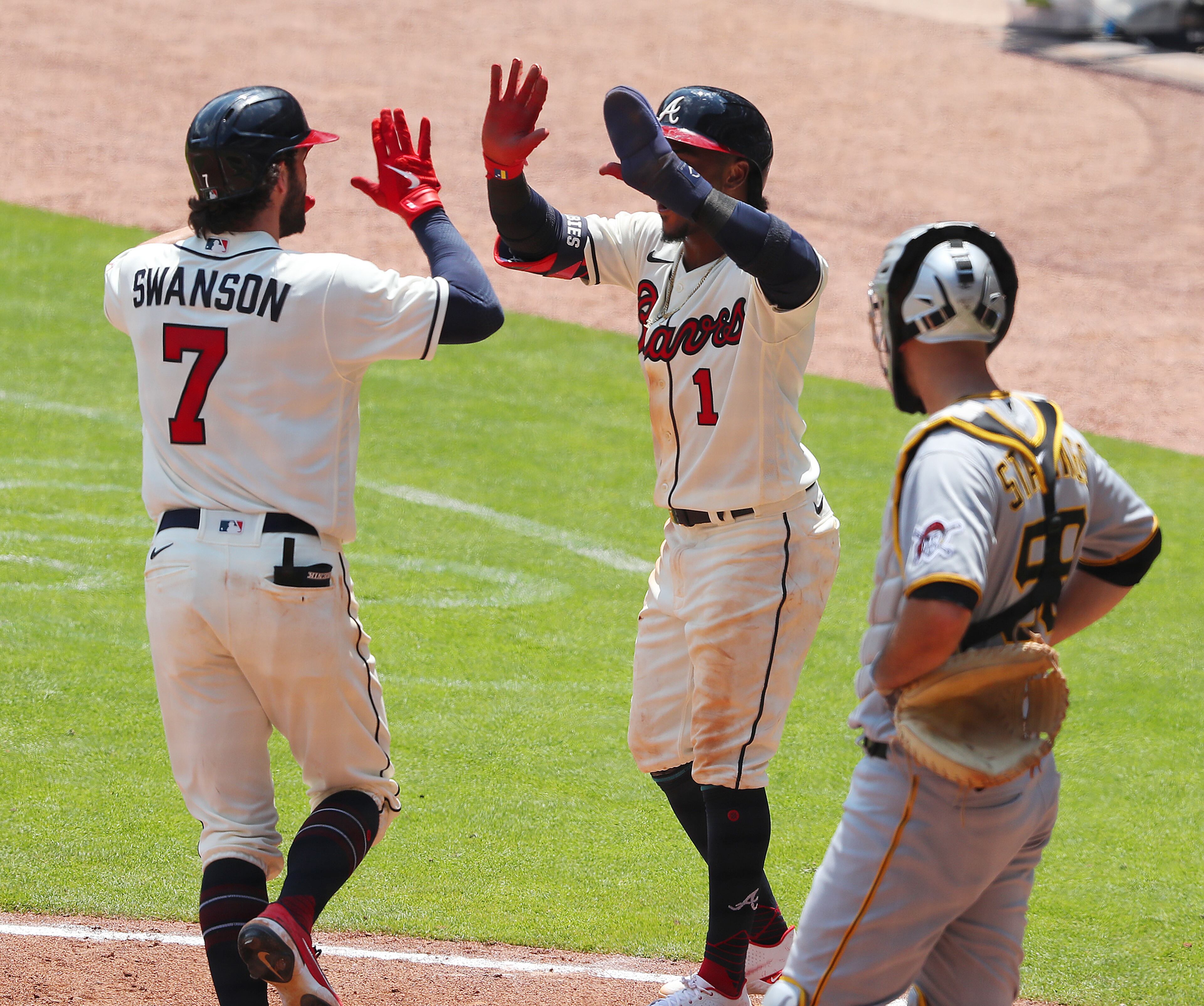 Braves batter Dansby Swanson (left) celebrates with teammate Ozzie Albies after hitting a two-run homer against the Pittsburgh Pirates Sunday, May 23, 2021, at Truist Park in Atlanta. (Curtis Compton / Curtis.Compton@ajc.com)